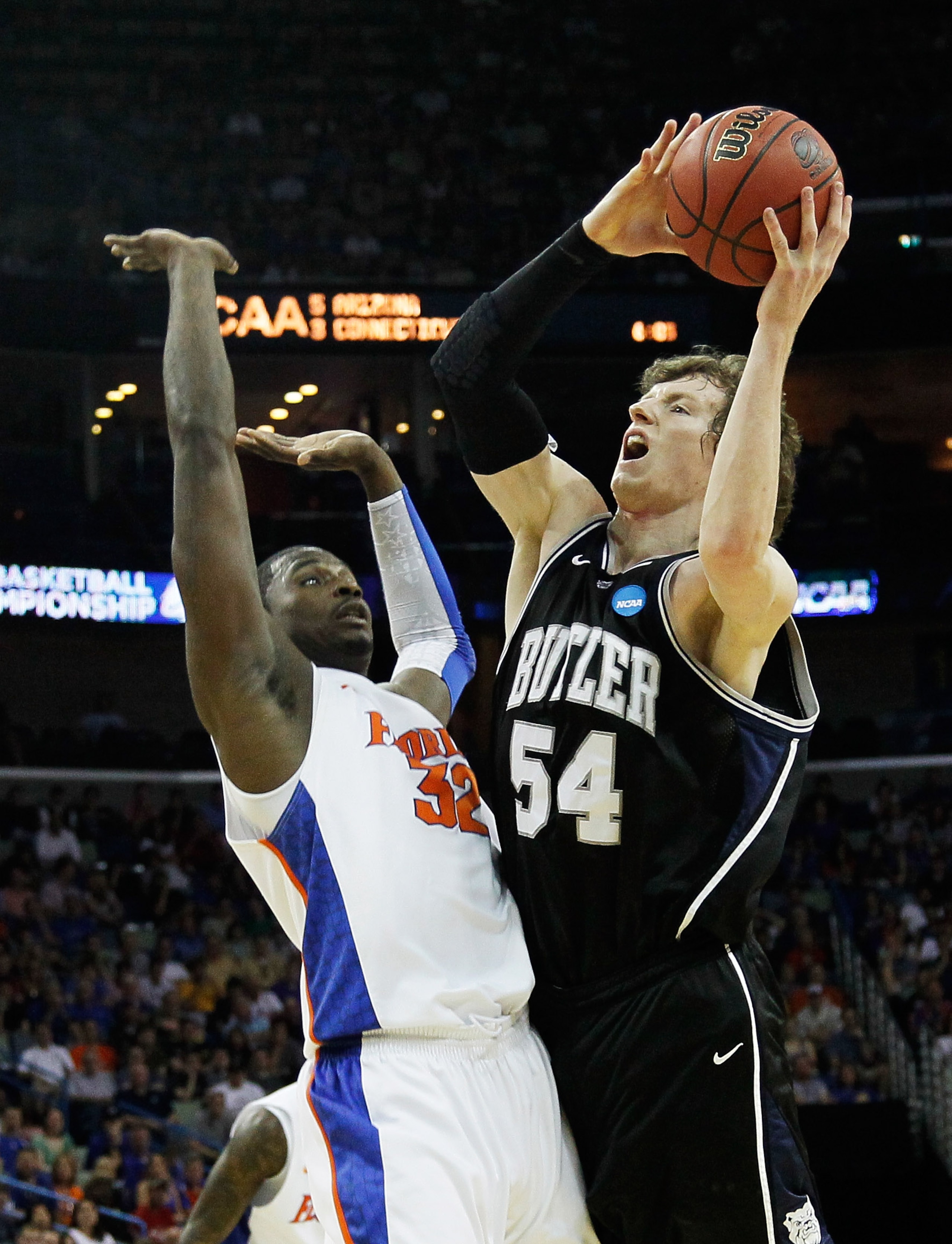 NEW ORLEANS, LA - MARCH 26:  Matt Howard #54 of the Butler Bulldogs shoots over Vernon Macklin #32 of the Florida Gators during the Southeast regional final of the 2011 NCAA men's basketball tournament at New Orleans Arena on March 26, 2011 in New Orleans