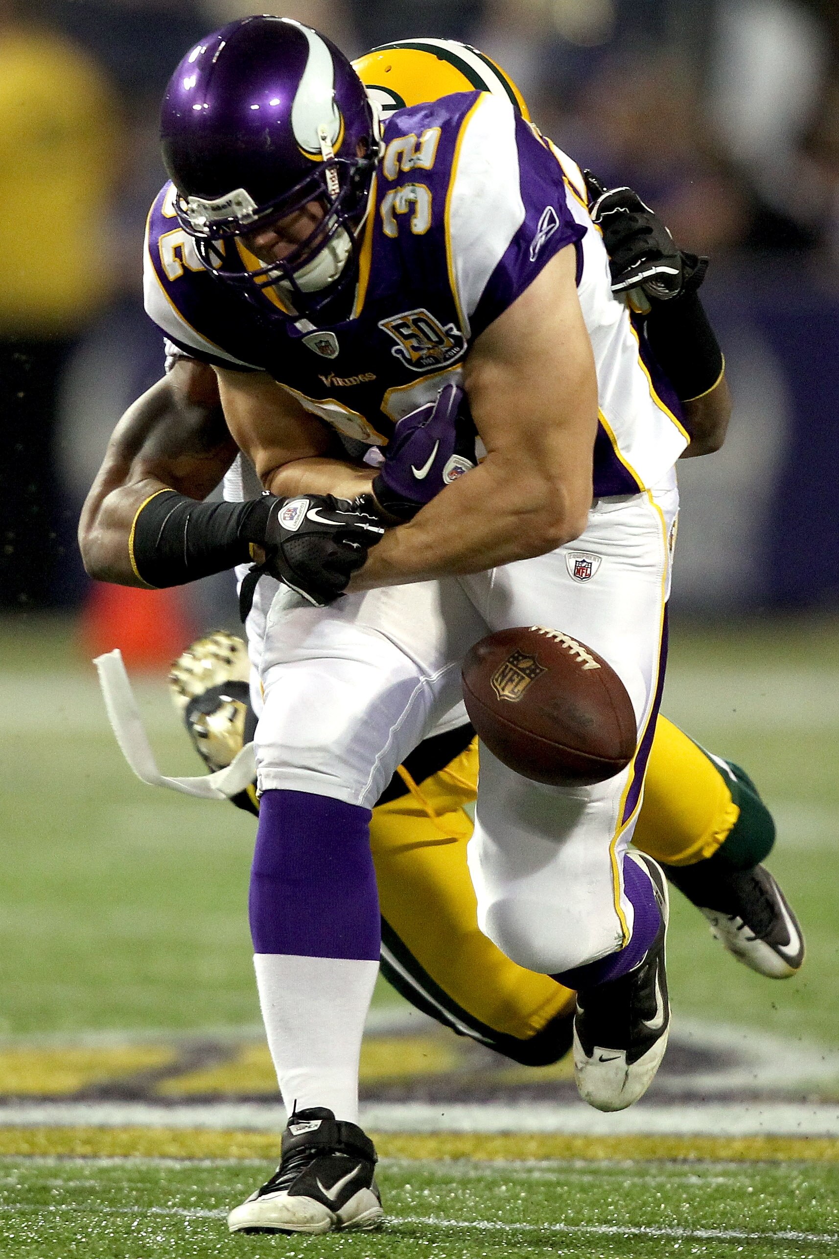 MINNEAPOLIS - NOVEMBER 21:  Toby Gerhart #32 of the Minnesota Vikings has the ball jarred loose by Charles Woodson #21 of the Green Bay Packers at the Hubert H. Humphrey Metrodome on November 21, 2010 in Minneapolis, Minnesota.  (Photo by Matthew Stockman