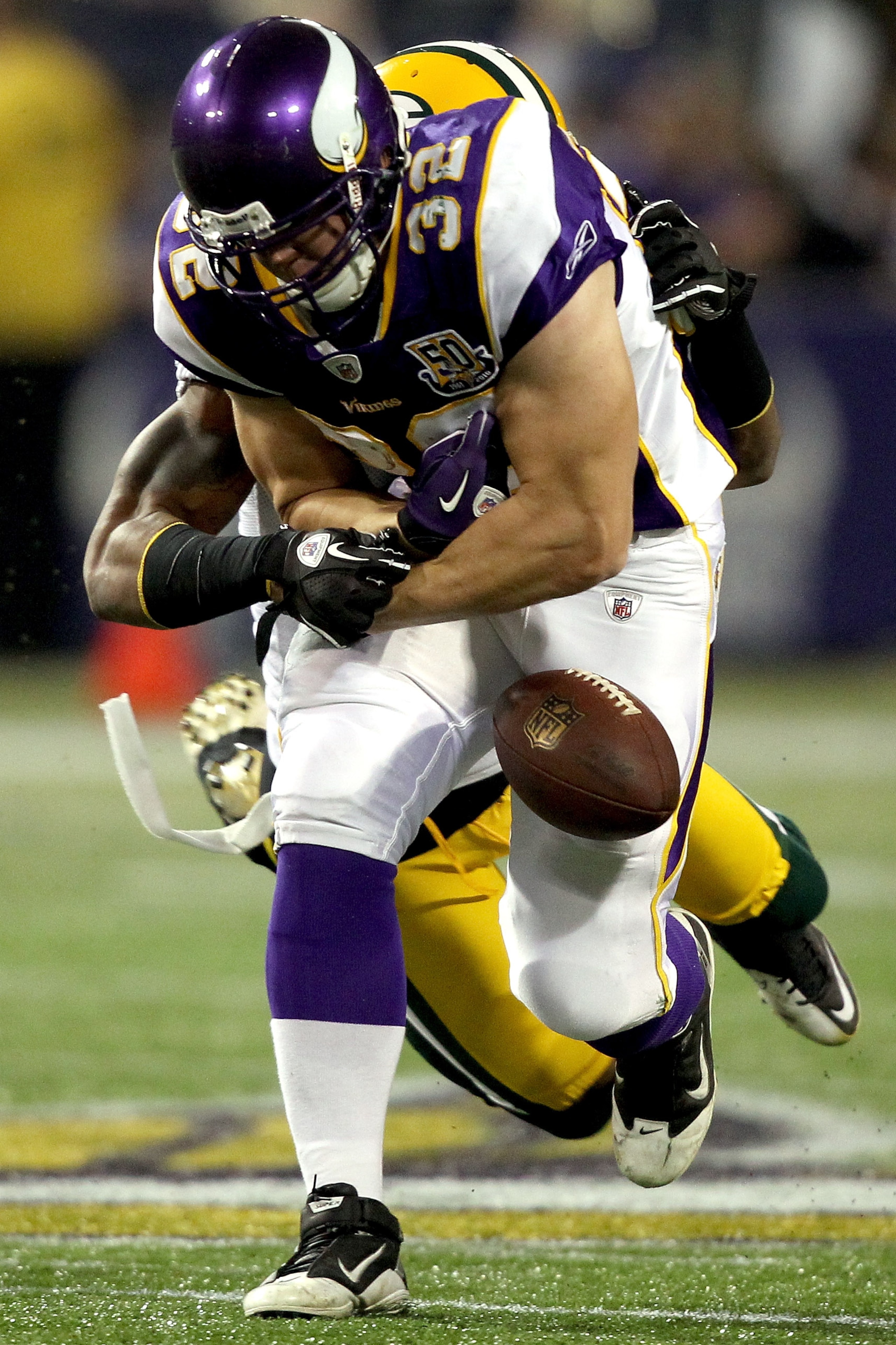 MINNEAPOLIS - NOVEMBER 21:  Toby Gerhart #32 of the Minnesota Vikings has the ball jarred loose by Charles Woodson #21 of the Green Bay Packers at the Hubert H. Humphrey Metrodome on November 21, 2010 in Minneapolis, Minnesota.  (Photo by Matthew Stockman