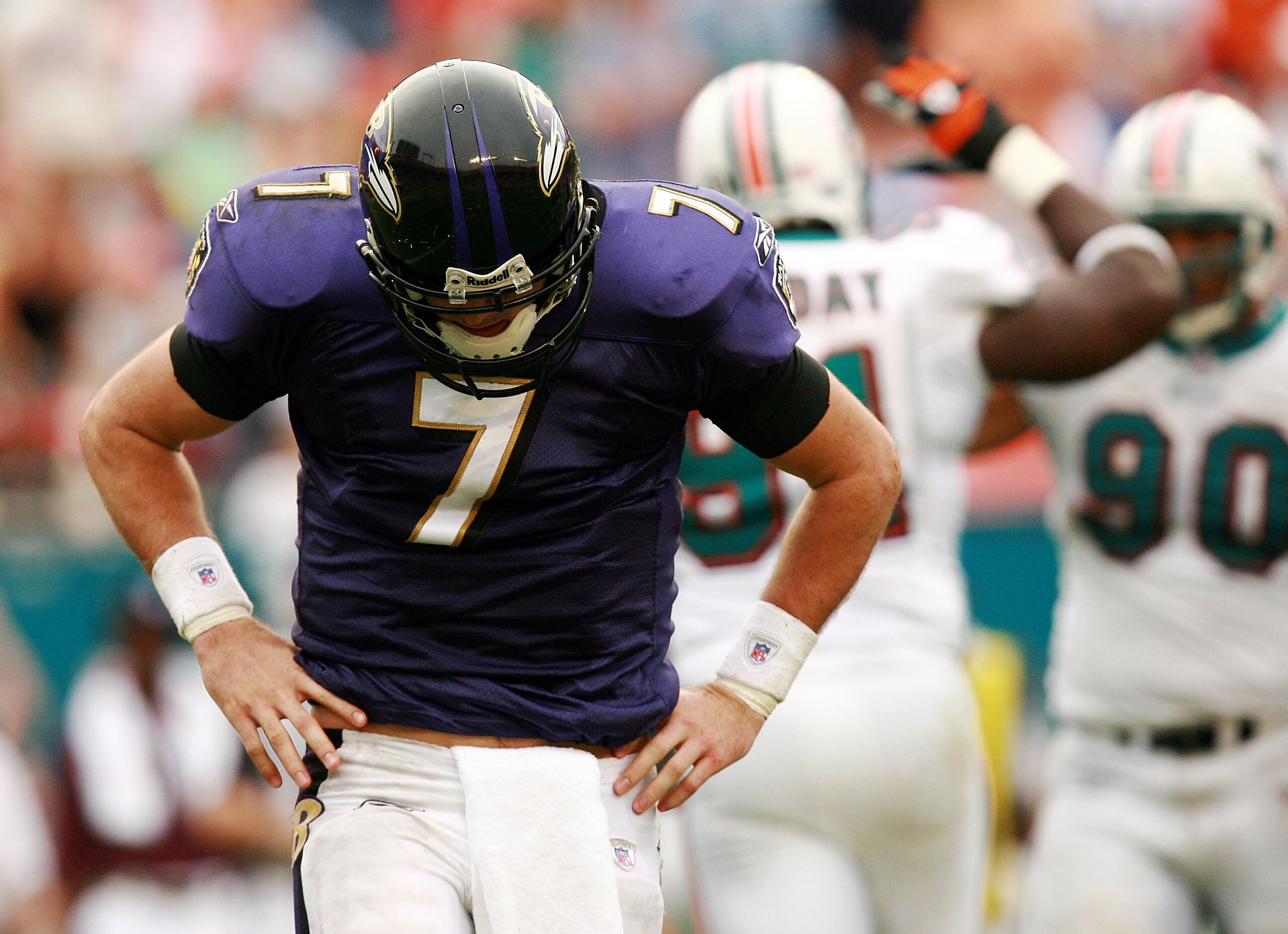 MIAMI - DECEMBER 16:  Quarterback Kyle Boller #7 of the Baltimore Ravens reacts after being hit while throwing by defensive tackle Vonnie Holliday #91 and Rodrique Wright #90 of the Miami Dolphins at Dolphin Stadium on December 16, 2007 in Miami, Florida.