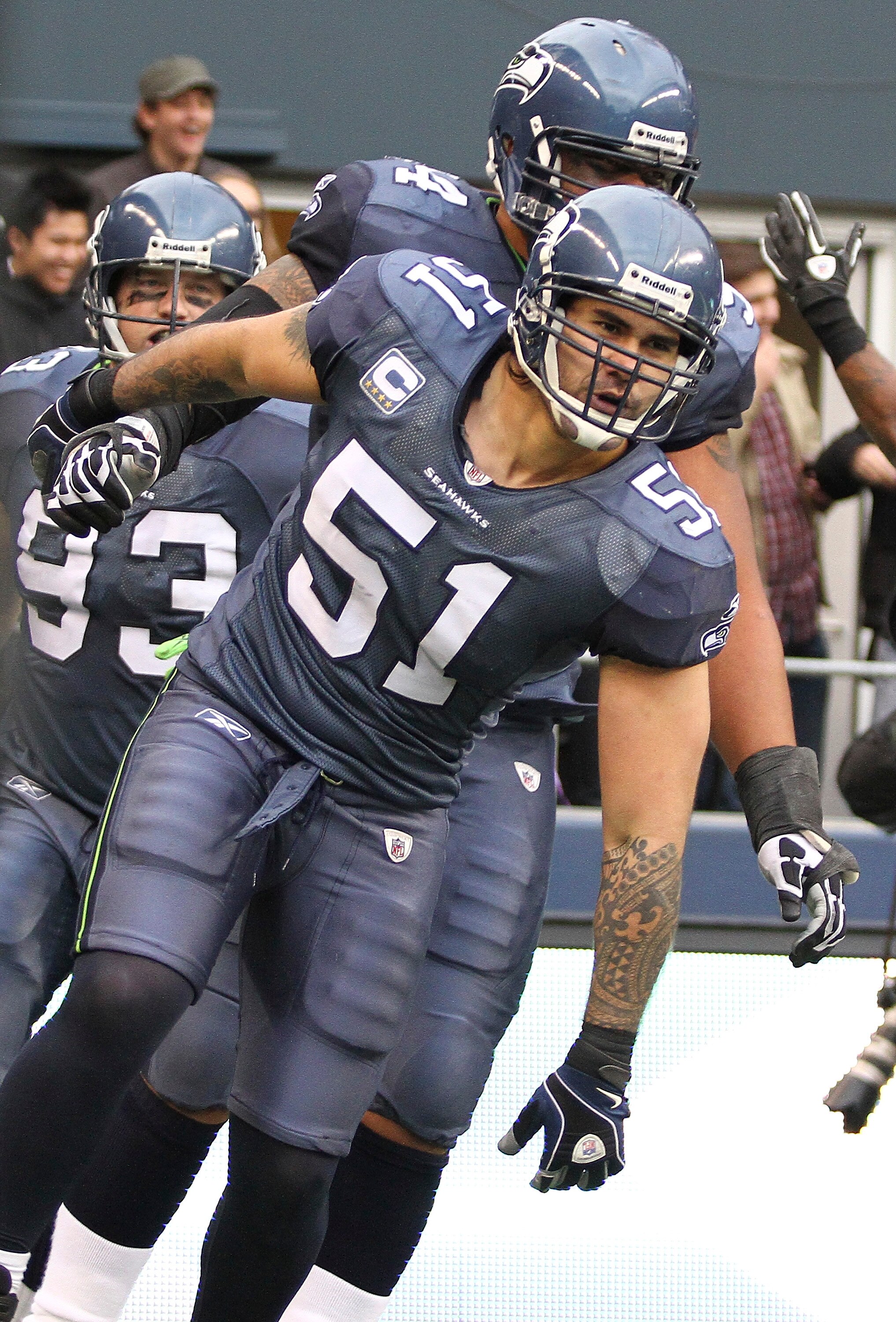 SEATTLE, WA - DECEMBER 05:  Linebacker Lofa Tatupu #51 of the Seattle Seahawks celebrates with teammates after returning an interception for a touchdown against the Carolina Panthers at Qwest Field on December 5, 2010 in Seattle, Washington. The Seahawks