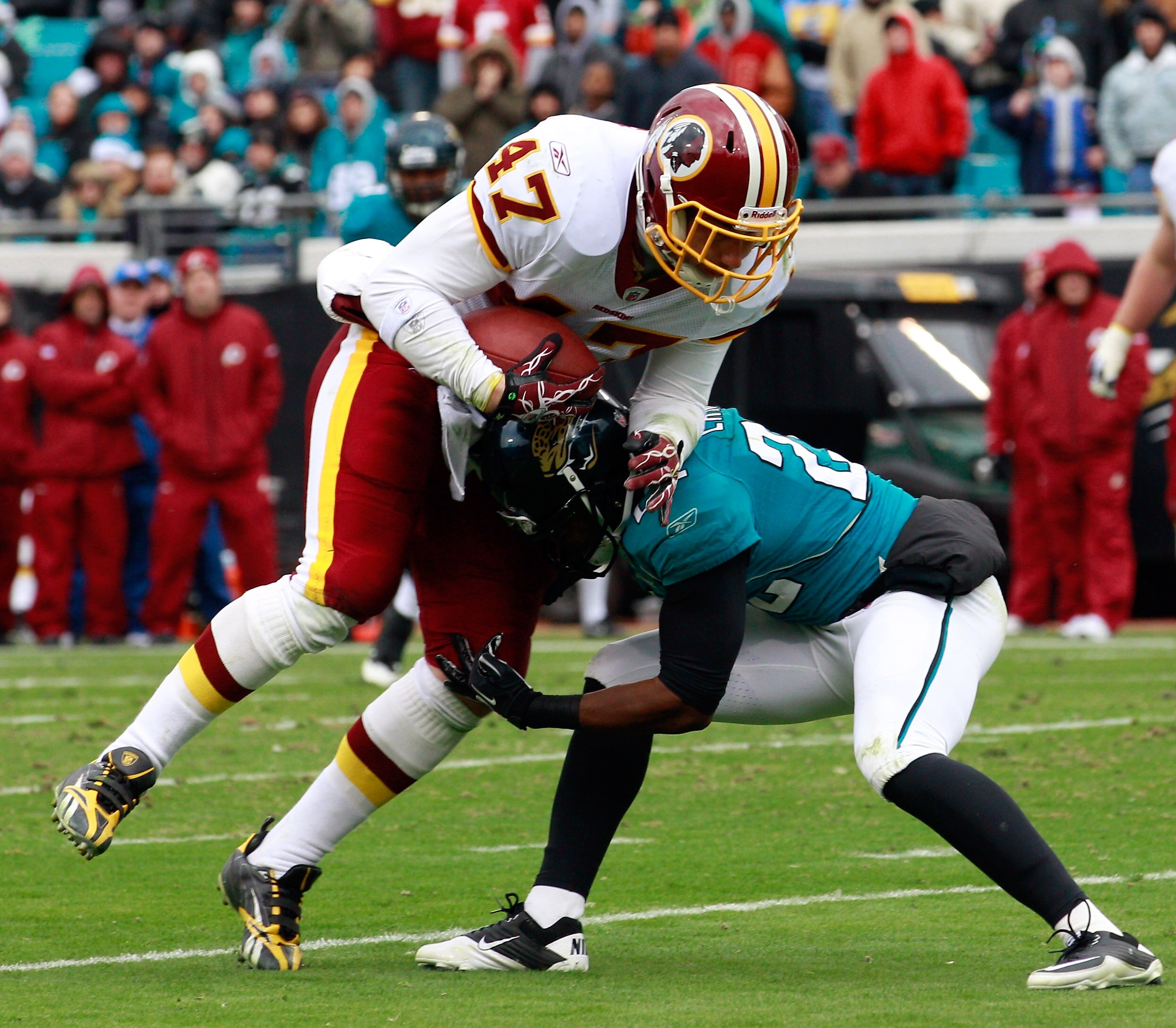 JACKSONVILLE, FL - DECEMBER 26:  Chris Cooley #47 of the Washington Redskins is tackled by Don Carey #22 of the Jacksonville Jaguars  during the game at EverBank Field on December 26, 2010 in Jacksonville, Florida.  (Photo by Sam Greenwood/Getty Images)