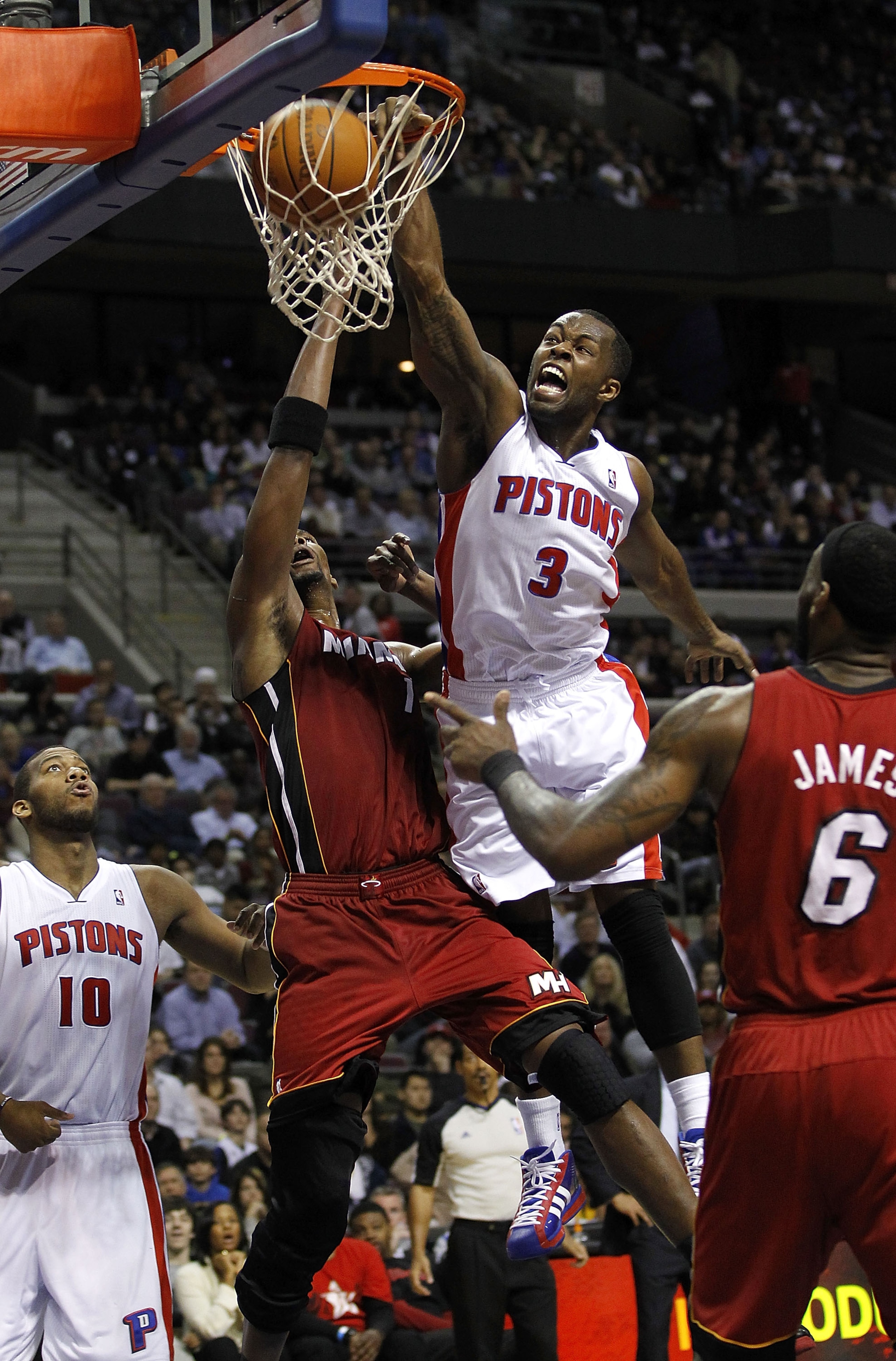 AUBURN HILLS, MI - MARCH 23: Rodney Stuckey #3 Detroit Pistons gets in for a dunk between Chris Bosh #1 and LeBron James #6 of the  Miami Heat at The Palace of Auburn Hills on March 23, 2011 in Auburn Hills, Michigan. Miami won the game 100-94. NOTE TO US