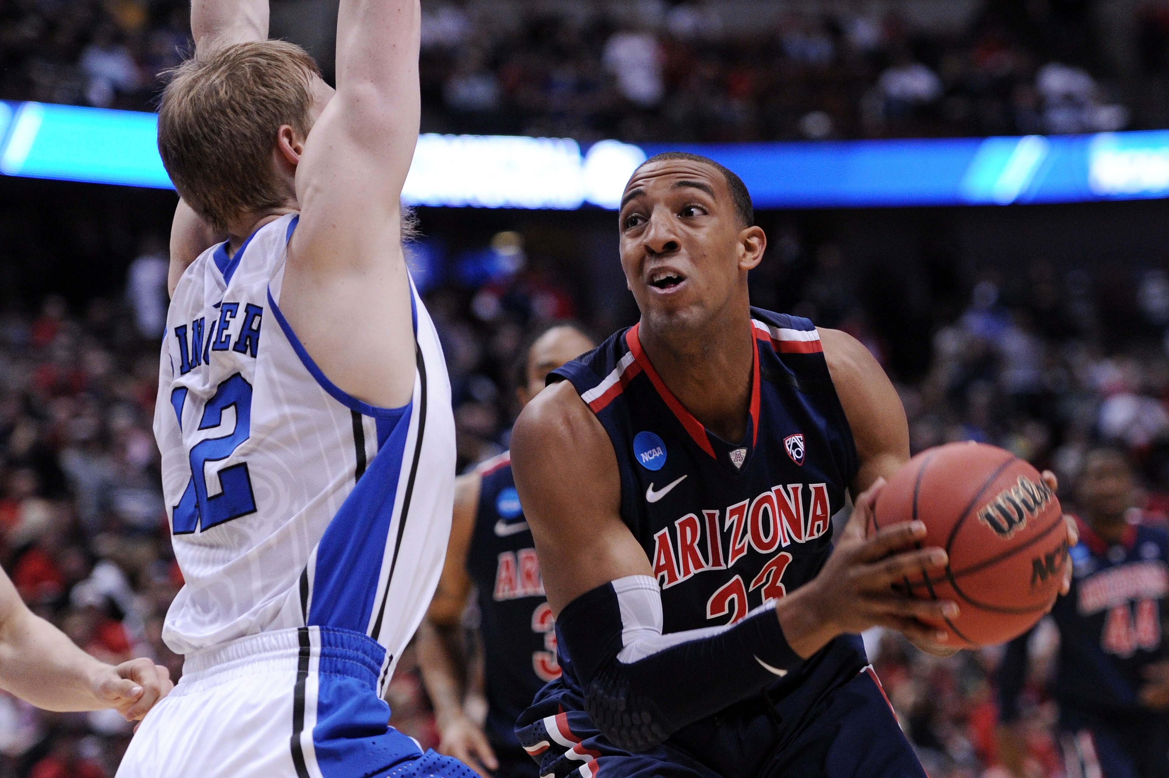 ANAHEIM, CA - MARCH 24: Derrick Williams #23 of the Arizona Wildcats handles the ball against Kyle Singler #12 of the Duke Blue Devils during the west regional semifinal of the 2011 NCAA men's basketball tournament at the Honda Center on March 24, 2011 ANAHEIM, CA - MARCH 24: Derrick Williams #23 of the Arizona Wildcats handles the ball against Kyle Singler #12 of the Duke Blue Devils during the west regional semifinal of the 2011 NCAA men's basketball tournament at the Honda Center on March 24, 2011