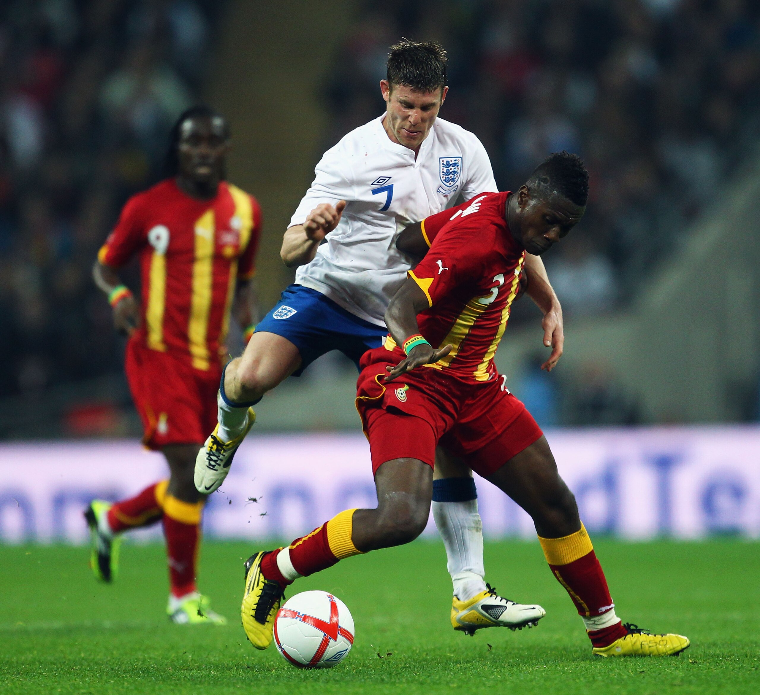 LONDON, ENGLAND - MARCH 29: James Milner of England (C) attempts to tackle Asamoah Gyan of Ghana during the international friendly match between England and Ghana at Wembley Stadium on March 29, 2011 in London, England. (Photo by Julian Finney/Getty Ima LONDON, ENGLAND - MARCH 29: James Milner of England (C) attempts to tackle Asamoah Gyan of Ghana during the international friendly match between England and Ghana at Wembley Stadium on March 29, 2011 in London, England. (Photo by Julian Finney/Getty Ima