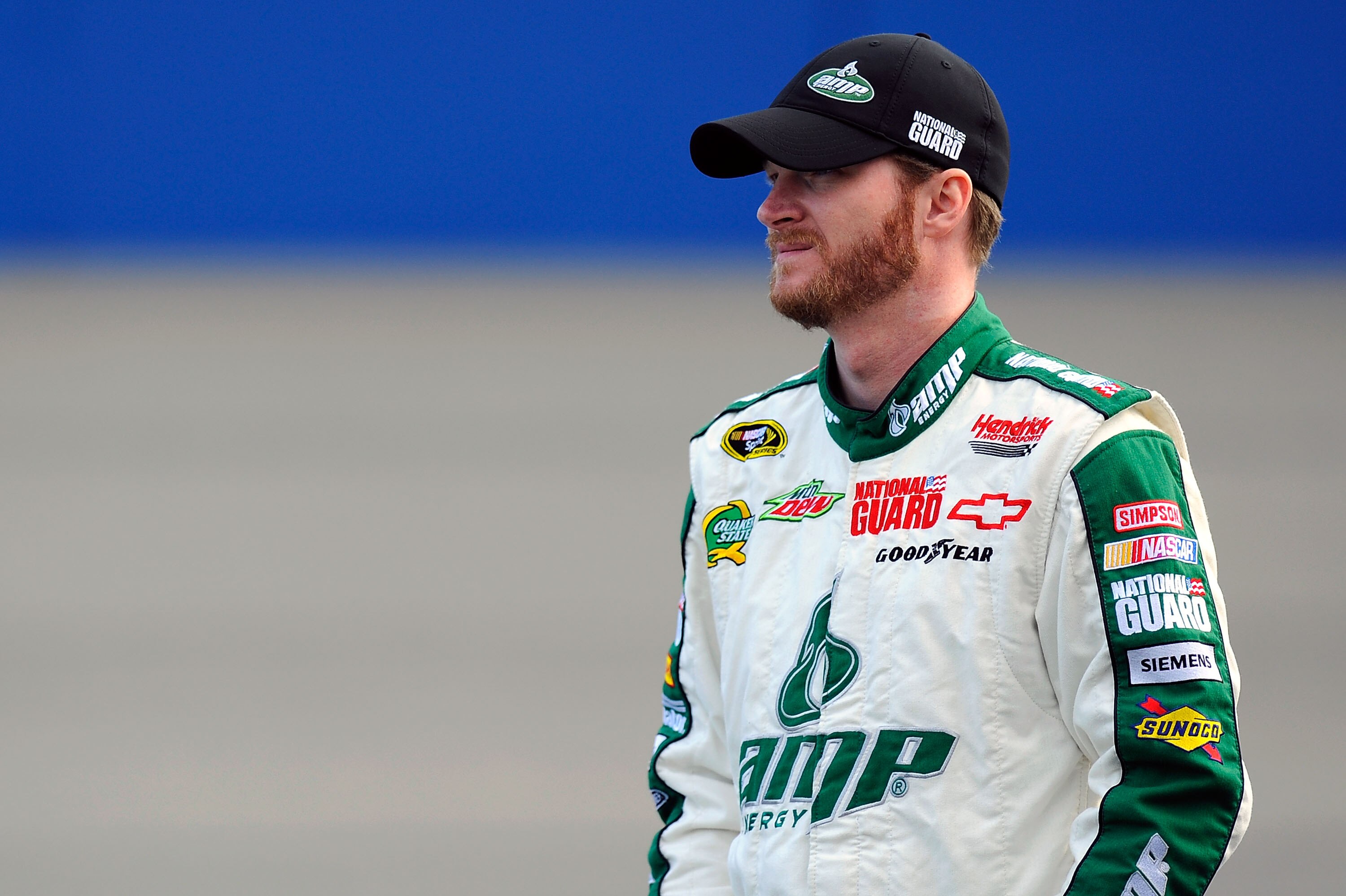 FONTANA, CA - MARCH 25:  Dale Earnhardt Jr., driver of the #88 AMP Energy/National Guard Chevrolet, stands on pit road during qualifying for the NASCAR Sprint Cup Series Auto Club 400 at Auto Club Speedway on March 25, 2011 in Fontana, California.  (Photo