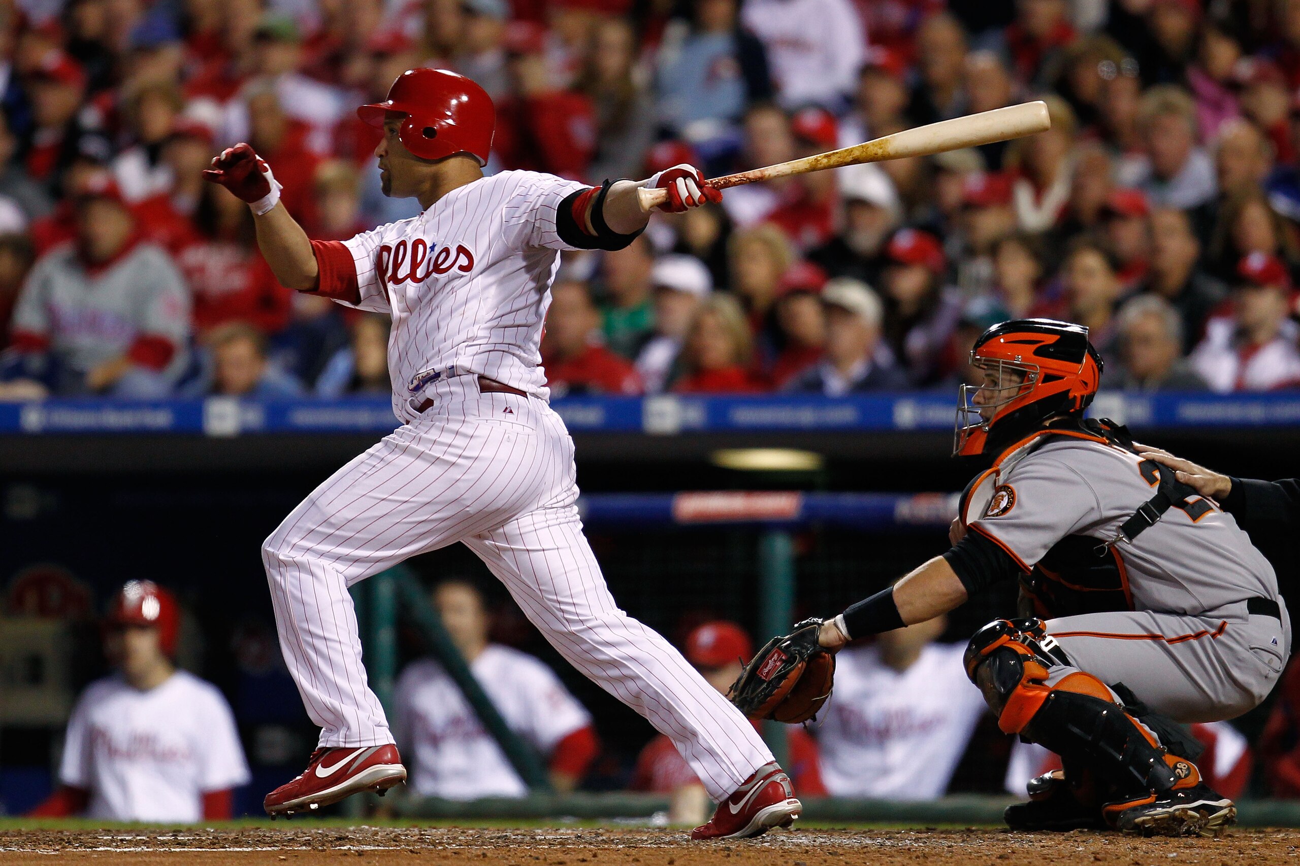 PHILADELPHIA - OCTOBER 17:  Placido Polanco #27 of the Philadelphia Phillies connects for a sacrifice fly to score Shane Victorino against the San Francisco Giants in Game Two of the NLCS during the 2010 MLB Playoffs at Citizens Bank Park on October 17, 2