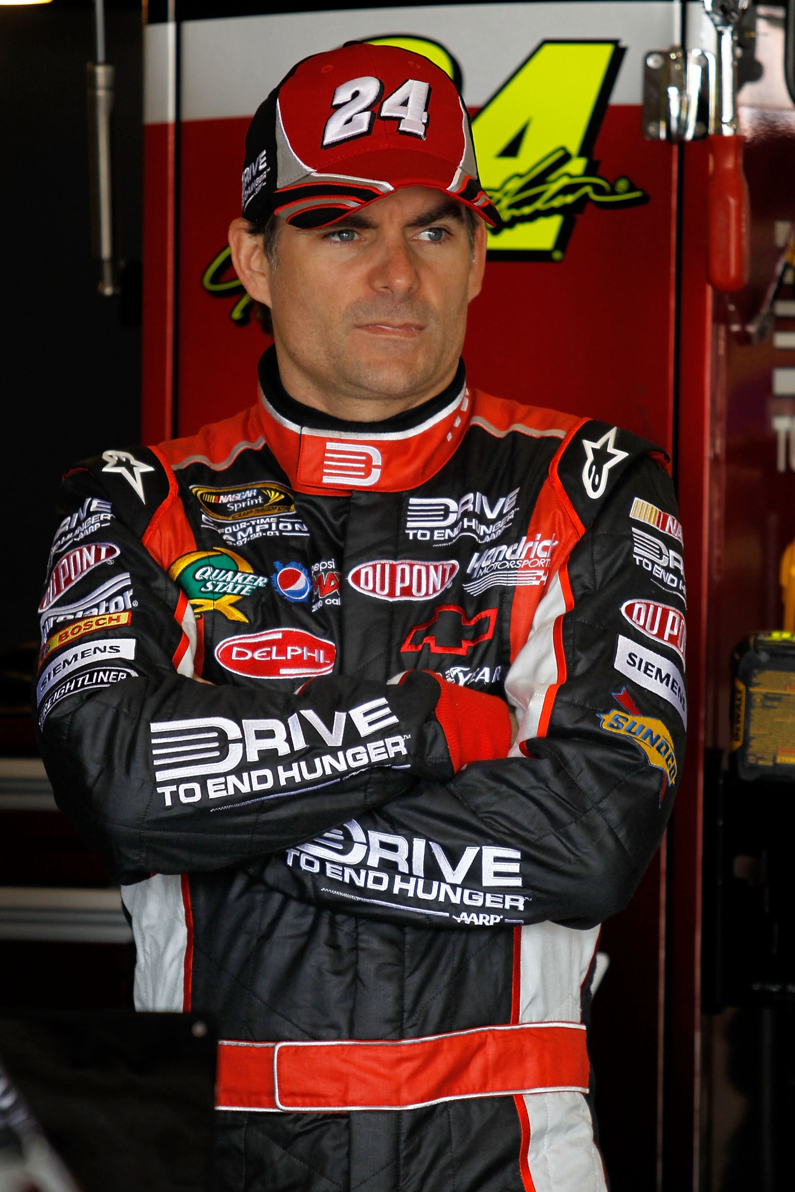 FONTANA, CA - MARCH 26:  Jeff Gordon, driver of the #24 Drive to End Hunger Chevrolet, stands in the garage area during practice for the NASCAR Sprint Cup Series Auto Club 400 at Auto Club Speedway on March 26, 2011 in Fontana, California.  (Photo by Todd