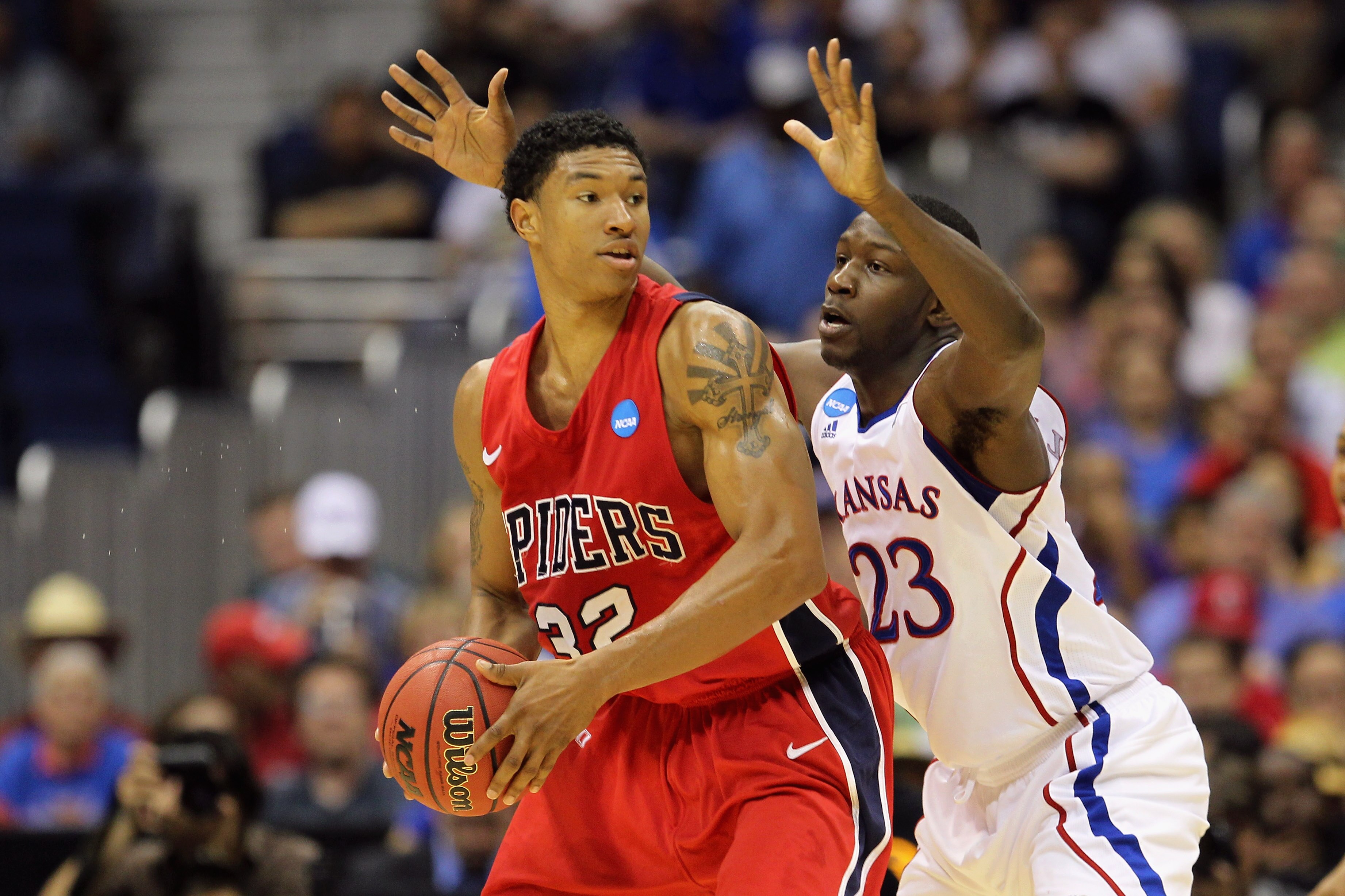 SAN ANTONIO, TX - MARCH 25:  Justin Harper #32 of the Richmond Spiders handles the ball against Mario Little #23 of the Kansas Jayhawks during the southwest regional of the 2011 NCAA men's basketball tournament at the Alamodome on March 25, 2011 in San An