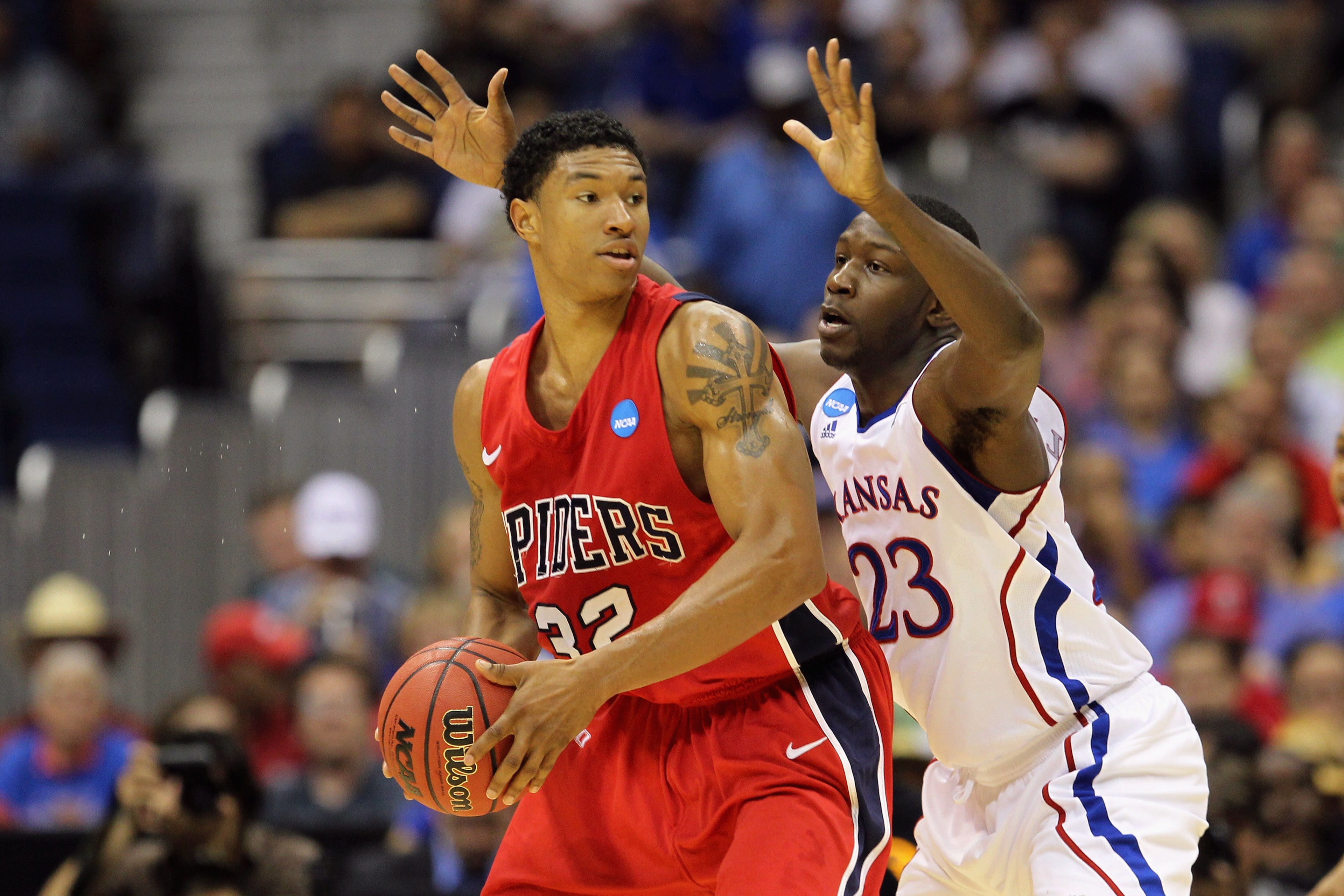 SAN ANTONIO, TX - MARCH 25: Justin Harper #32 of the Richmond Spiders handles the ball against Mario Little #23 of the Kansas Jayhawks during the southwest regional of the 2011 NCAA men's basketball tournament at the Alamodome on March 25, 2011 in San An SAN ANTONIO, TX - MARCH 25: Justin Harper #32 of the Richmond Spiders handles the ball against Mario Little #23 of the Kansas Jayhawks during the southwest regional of the 2011 NCAA men's basketball tournament at the Alamodome on March 25, 2011 in San An