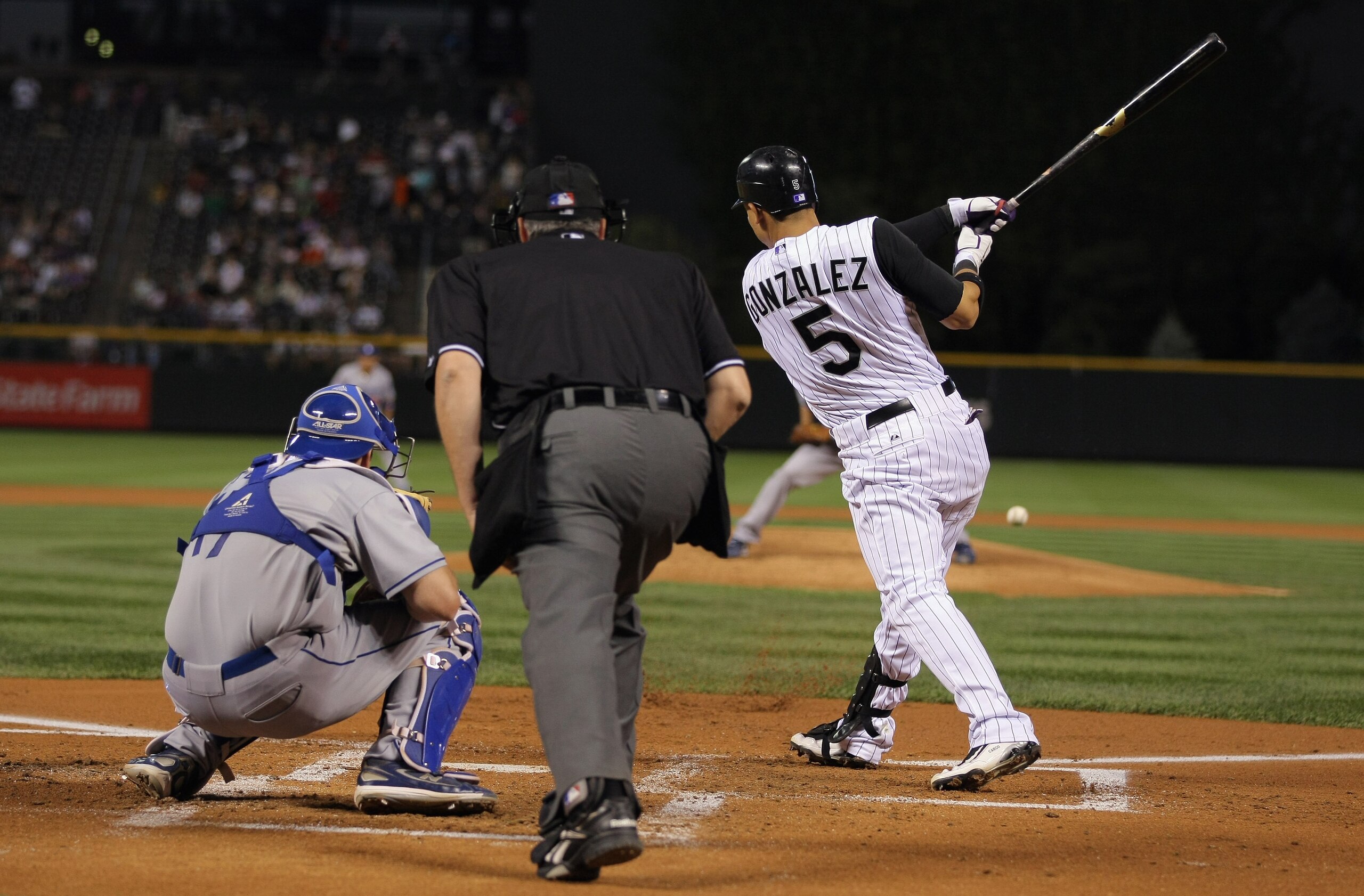 DENVER - SEPTEMBER 27:  Carlos Gonzalez #5 of the Colorado Rockies takes an at bat against the Los Angeles Dodgers at Coors Field on September 25, 2010 in Denver, Colorado. The Dodgers defeated the Rockies 3-1.  (Photo by Doug Pensinger/Getty Images)