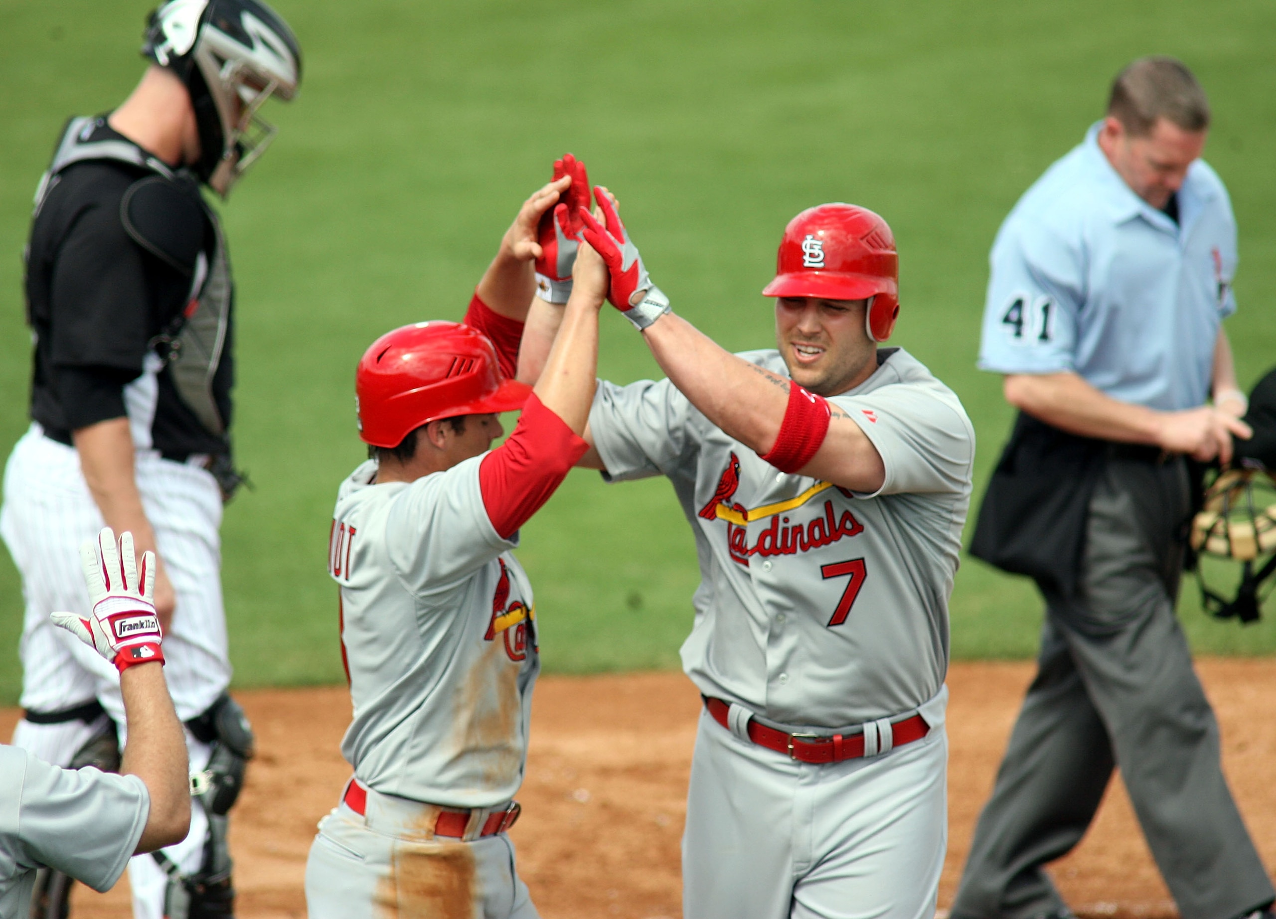 JUPITER, FL - MARCH 01:  Matt Holliday #7 of the St. Louis Cardinals celebrates his two run home run against the Florida Marlins with teammate Ryan Theriot #3 at Roger Dean Stadium on March 1, 2011 in Jupiter, Florida.  (Photo by Marc Serota/Getty Images)