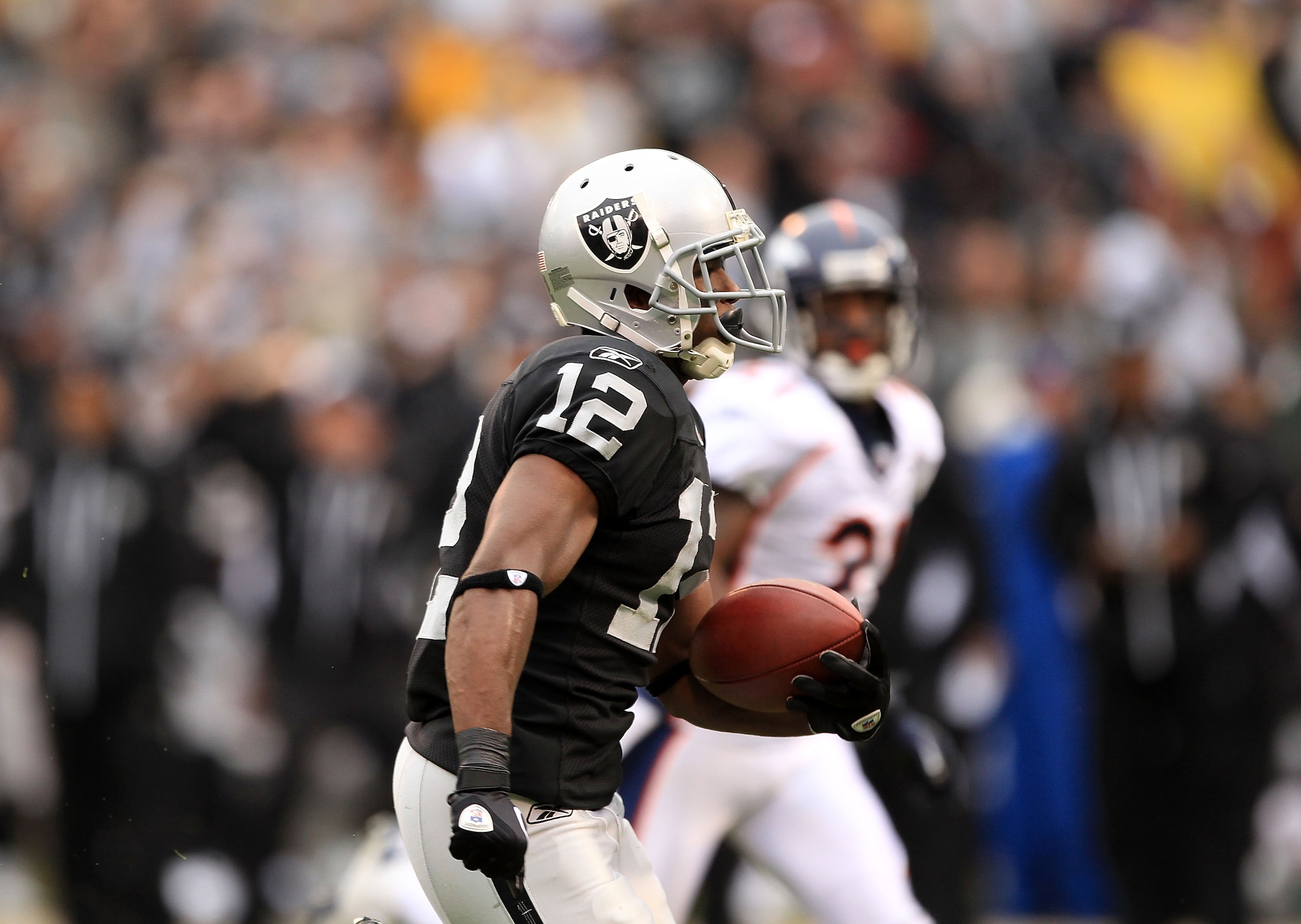 OAKLAND, CA - DECEMBER 19:  Jacoby Ford #12 of the Oakland Raiders runs in for a touchdown against the Denver Broncos at Oakland-Alameda County Coliseum on December 19, 2010 in Oakland, California.  (Photo by Ezra Shaw/Getty Images)