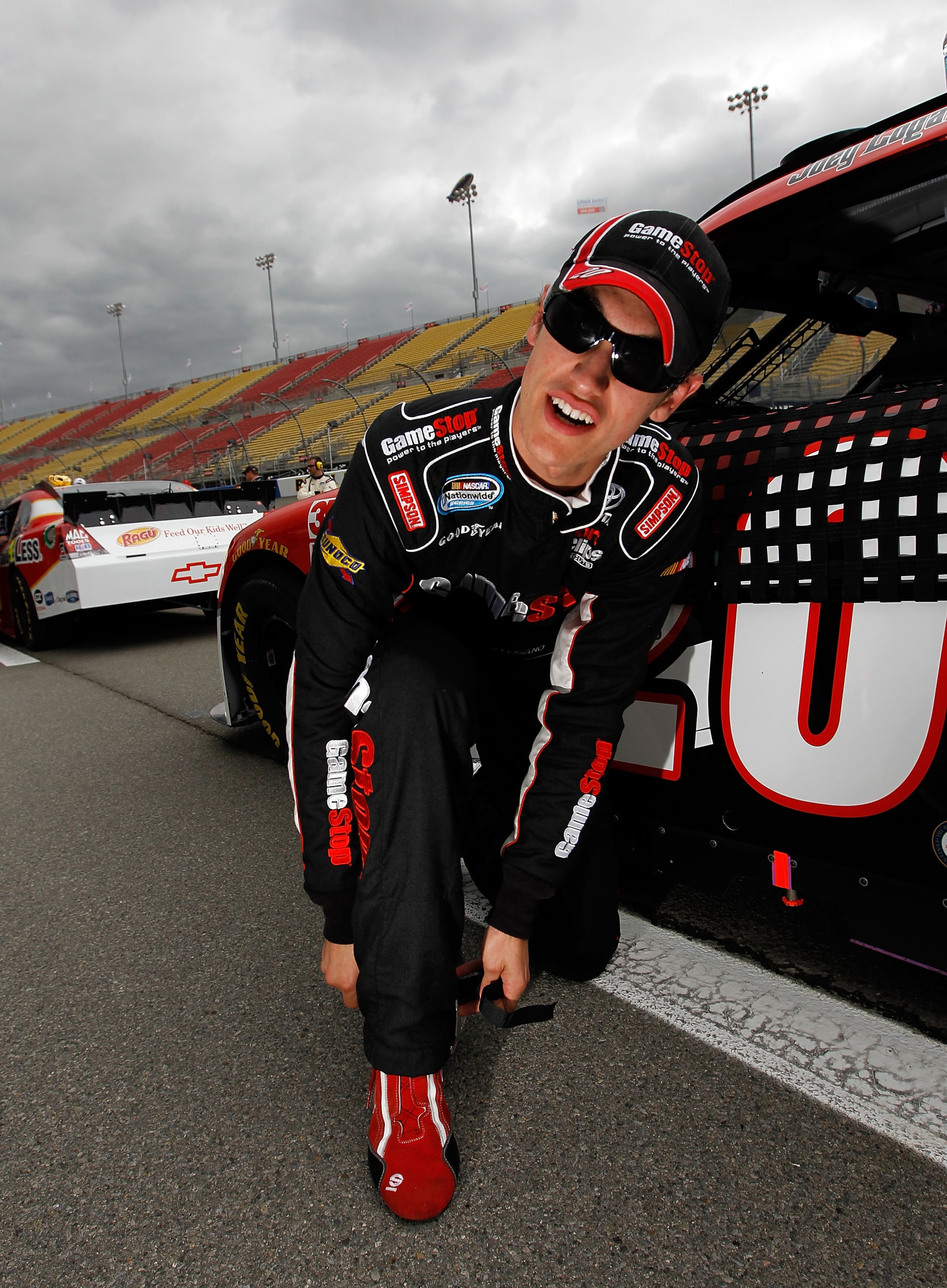 FONTANA, CA - MARCH 26:  Joey Logano, driver of the #20 GameStop Toyota, prepares to drive in the NASCAR Nationwide Series Royal Purple 300 at Auto Club Speedway on March 26, 2011 in Fontana, California.  (Photo by Tom Pennington/Getty Images)
