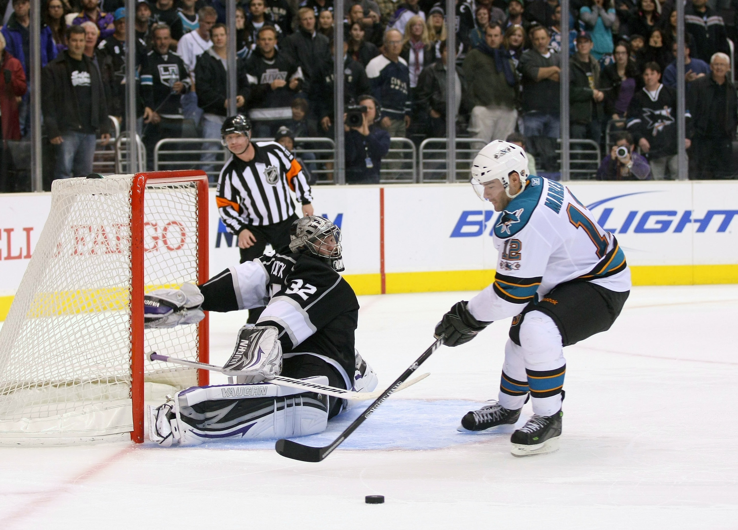 LOS ANGELES, CA - MARCH 24: Goaltender Jonathan Quick #32 of the Los Angeles Kings slides out his right leg pad to defend the shot as Patrick Marleau #12 of the San Jose Sharks loses control of the puck during his shootout attempt in the NHL game at Stap LOS ANGELES, CA - MARCH 24: Goaltender Jonathan Quick #32 of the Los Angeles Kings slides out his right leg pad to defend the shot as Patrick Marleau #12 of the San Jose Sharks loses control of the puck during his shootout attempt in the NHL game at Stap