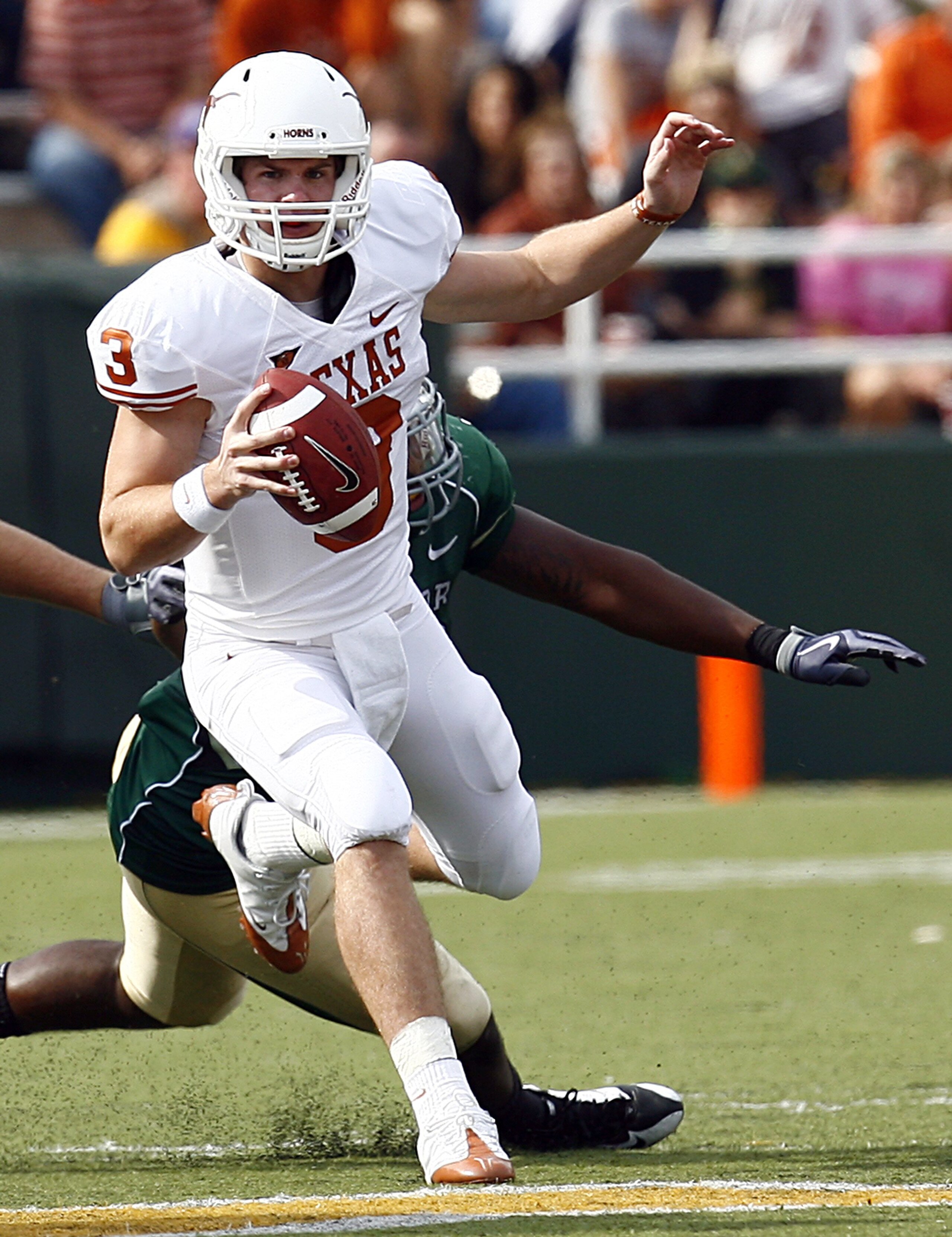 WACO, TX - NOVEMBER 14:  Quarterback Garrett Gilbert #3 of the Texas Longhorns scrambles witht he ball during the second half against the Baylor Bears on November 14, 2009 at Floyd Casey Stadium in Waco, Texas. (Photo by Tom Pennington/Getty Images)