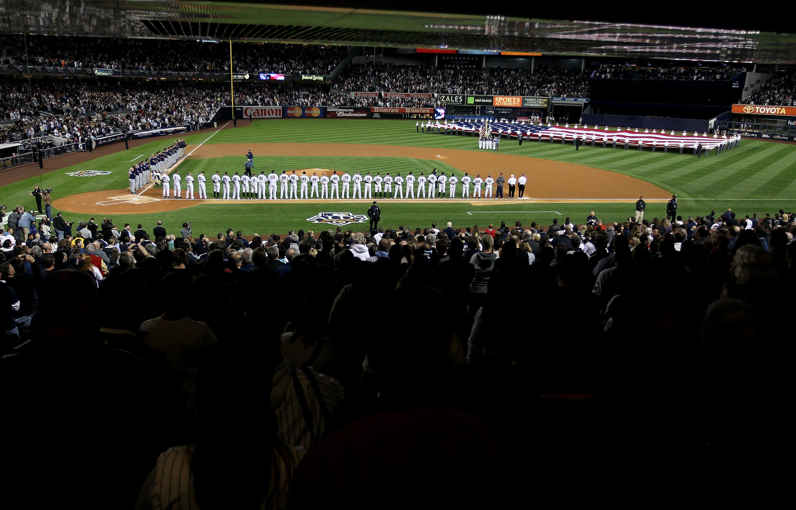 NEW YORK - OCTOBER 09: The New York Yankees and the Minnesota Twins stand for the performance of the National Anthem during Game Three of the ALDS part of the 2010 MLB Playoffs at Yankee Stadium on October 9, 2010 in the Bronx borough of New York City. NEW YORK - OCTOBER 09: The New York Yankees and the Minnesota Twins stand for the performance of the National Anthem during Game Three of the ALDS part of the 2010 MLB Playoffs at Yankee Stadium on October 9, 2010 in the Bronx borough of New York City.