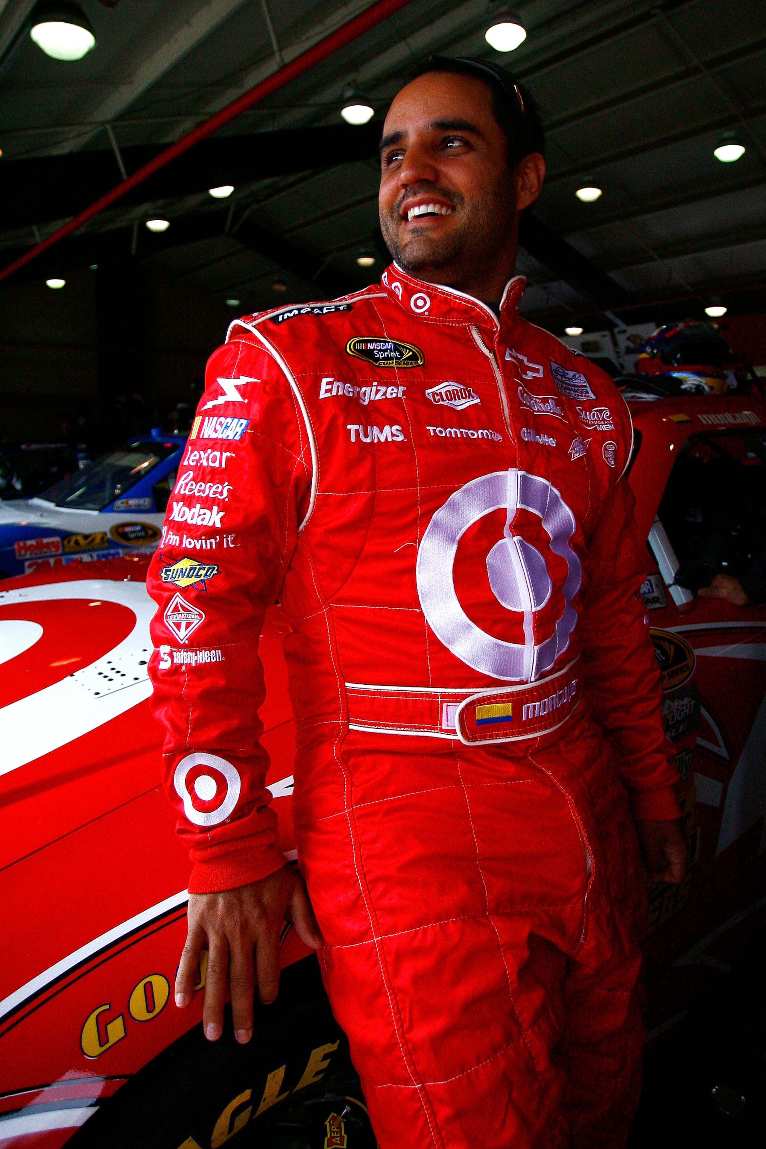 FONTANA, CA - MARCH 26:  Juan Pablo Montoya, driver of the #42 Target Chevrolet, stands in the garage area during practice for the NASCAR Sprint Cup Series Auto Club 400 at Auto Club Speedway on March 26, 2011 in Fontana, California.  (Photo by Jason Smit