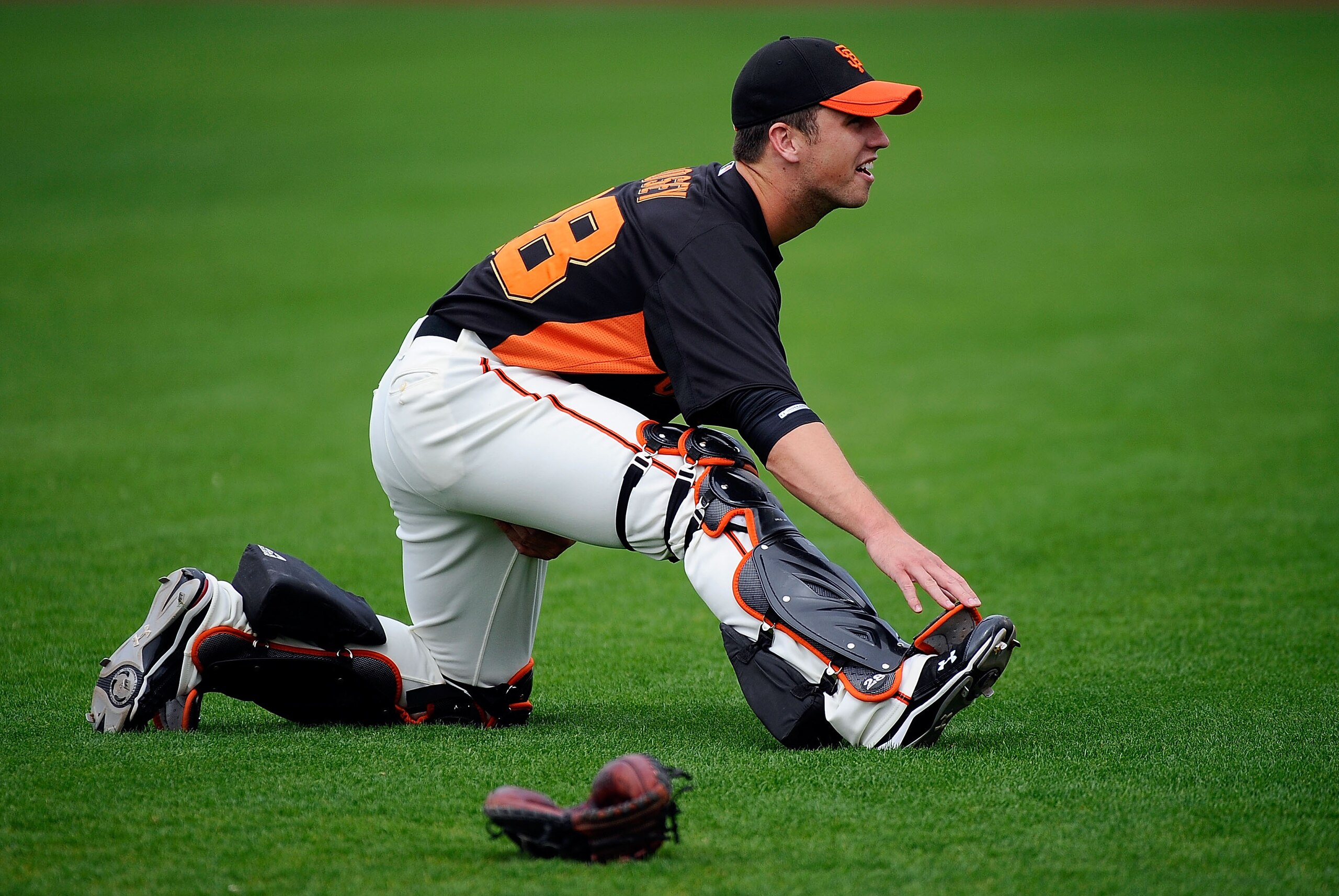 SCOTTSDALE, AZ - MARCH 14:  Buster Posey #28 of the San Francisco Giants stretches before playing against the Milwaukee Brewers during the spring training baseball game at Scottsdale Stadium on March 14, 2011 in Scottsdale, Arizona.  (Photo by Kevork Djan