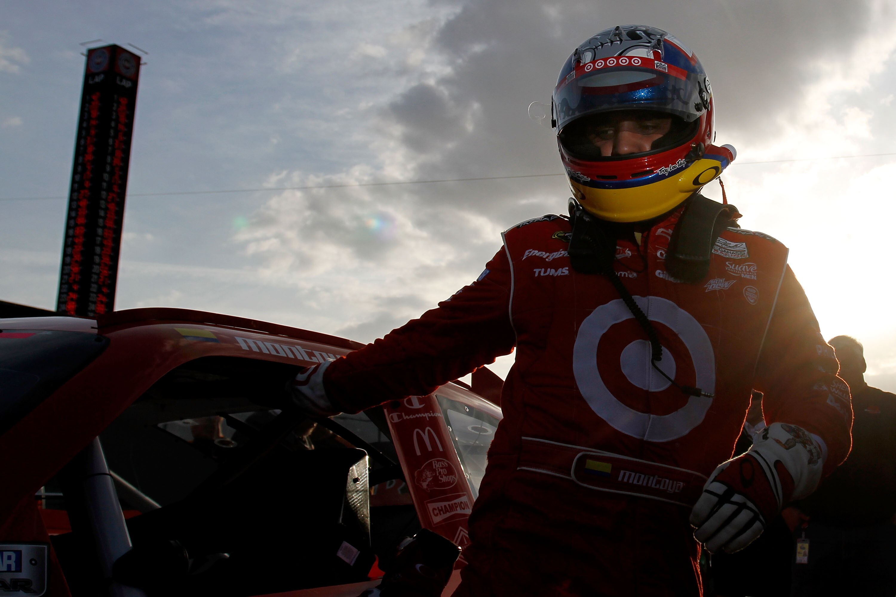 FONTANA, CA - MARCH 25:  Juan Pablo Montoya, driver of the #42 Target Chevrolet, climbs from his car after setting the pole position in qualifying for the NASCAR Sprint Cup Series Auto Club 400 at Auto Club Speedway on March 25, 2011 in Fontana, Californi
