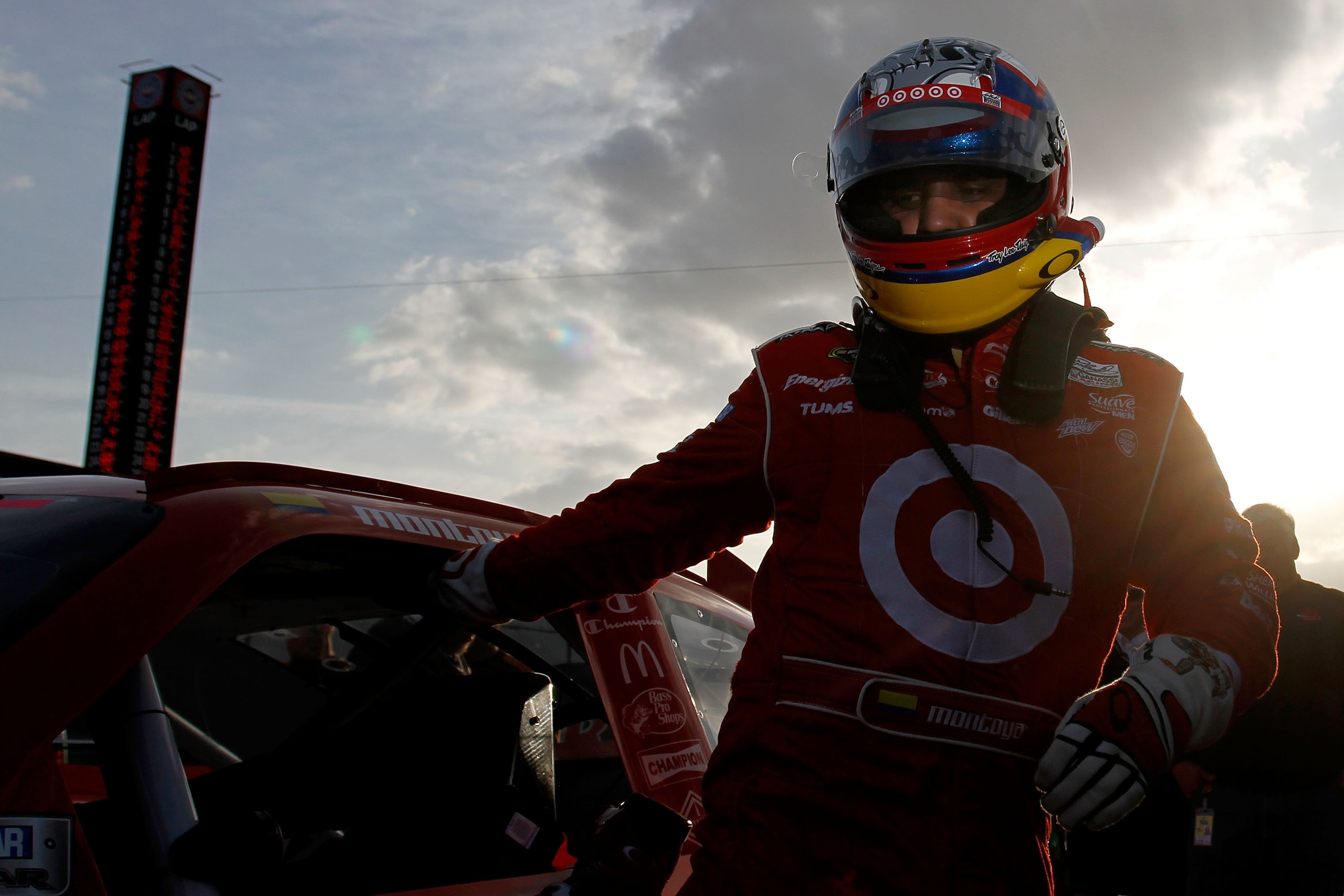 FONTANA, CA - MARCH 25:  Juan Pablo Montoya, driver of the #42 Target Chevrolet, climbs from his car after setting the pole position in qualifying for the NASCAR Sprint Cup Series Auto Club 400 at Auto Club Speedway on March 25, 2011 in Fontana, Californi