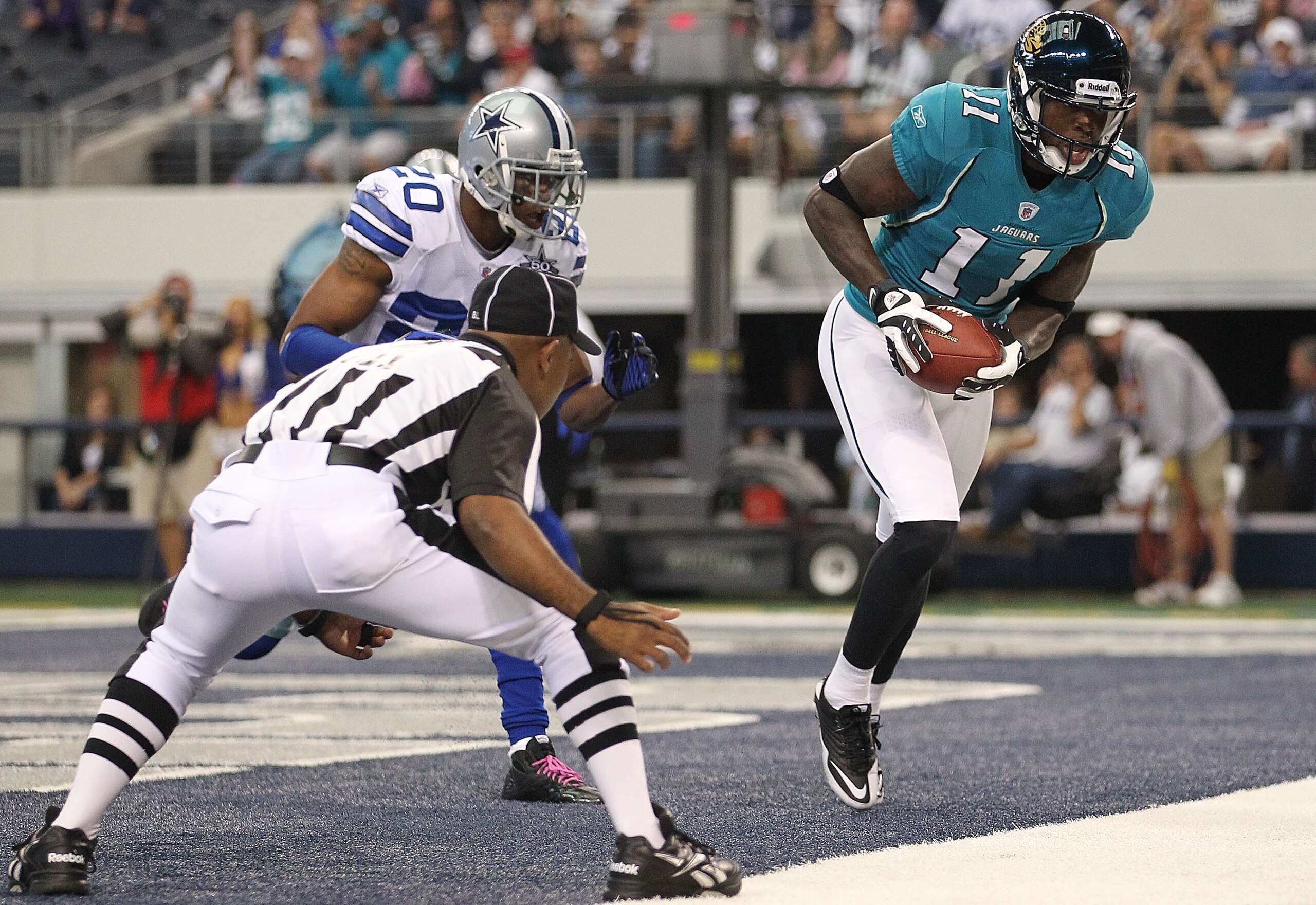 ARLINGTON, TX - OCTOBER 31: Wide receiver Mike Sims-Walker #11 of the Jacksonville Jaguars makes a touchdown pass reception against Alan Ball #20 of the Dallas Cowboys in the first quarter at Cowboys Stadium on October 31, 2010 in Arlington, Texas. (Pho ARLINGTON, TX - OCTOBER 31: Wide receiver Mike Sims-Walker #11 of the Jacksonville Jaguars makes a touchdown pass reception against Alan Ball #20 of the Dallas Cowboys in the first quarter at Cowboys Stadium on October 31, 2010 in Arlington, Texas. (Pho