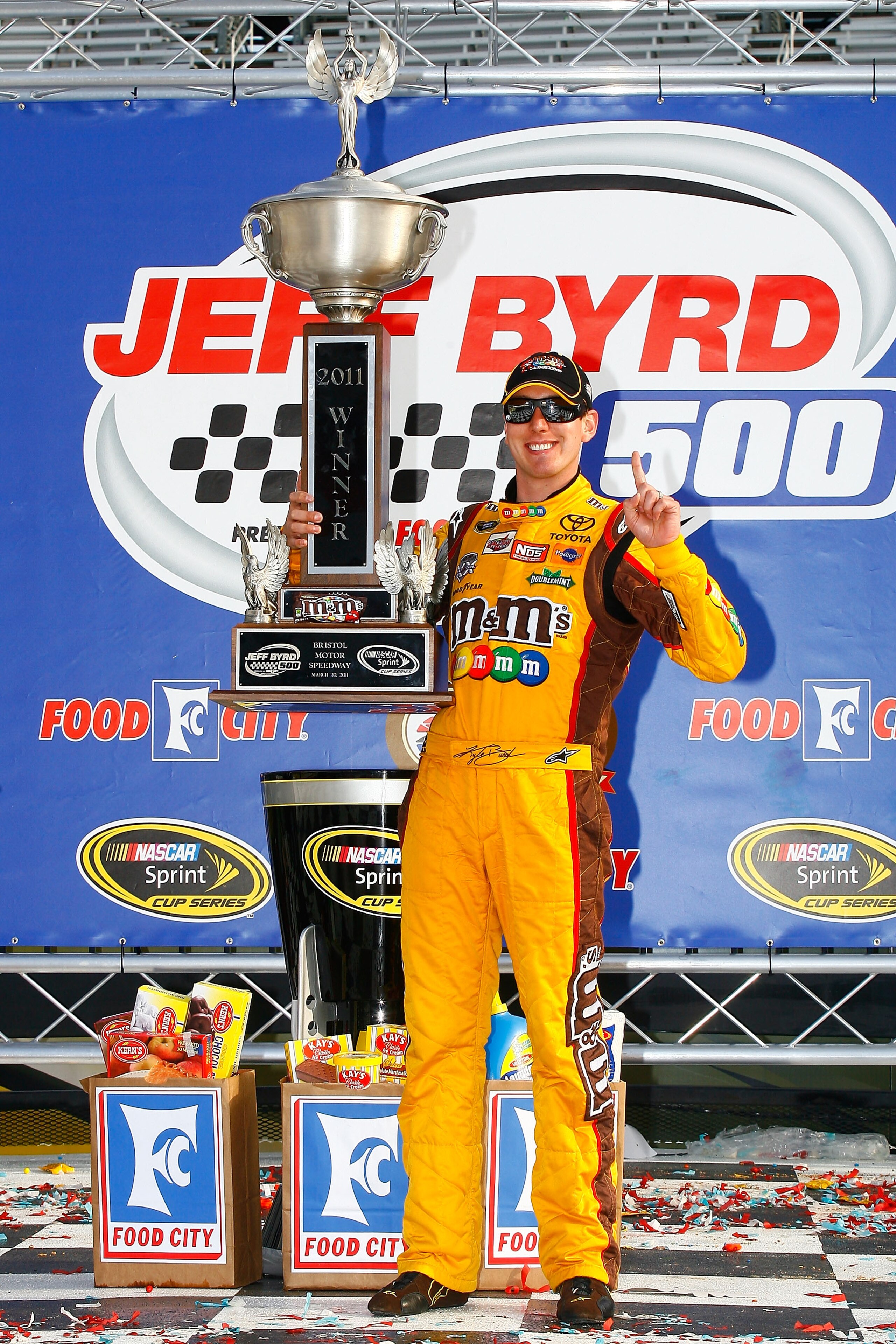 BRISTOL, TN - MARCH 20:  Kyle Busch, driver of the #18 M&M's Toyota, celebrates in Victory Lane after winning the NASCAR Sprint Cup Series Jeff Byrd 500 Presented By Food City at Bristol Motor Speedway on March 20, 2011 in Bristol, Tennessee.  (Photo by J