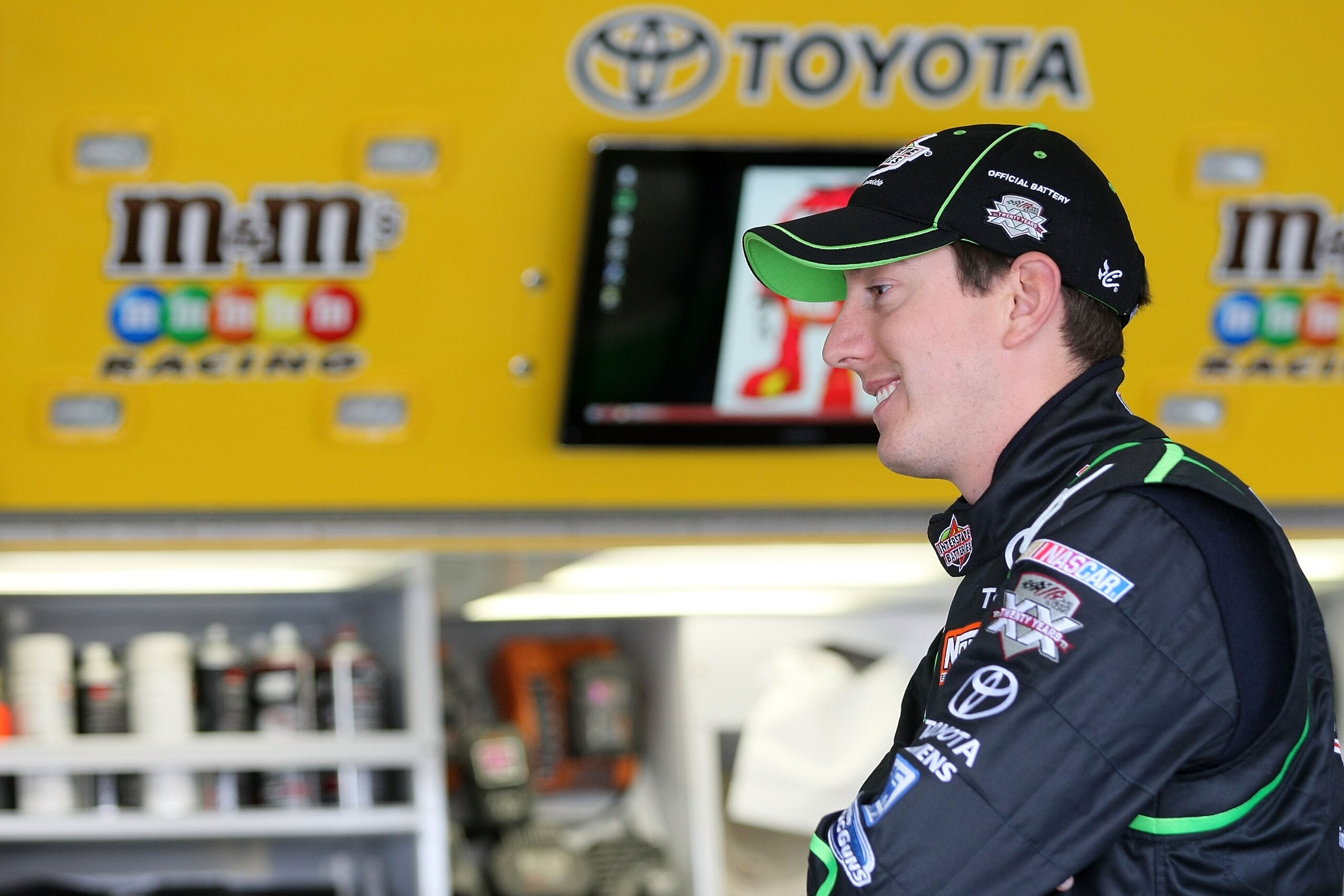 FONTANA, CA - MARCH 25:  Kyle Busch, driver of the #18 Interstate Batteries Toyota, stands in the garage area during practice for the NASCAR Sprint Cup Series Auto Club 400 at Auto Club Speedway on March 25, 2011 in Fontana, California.  (Photo by Victor