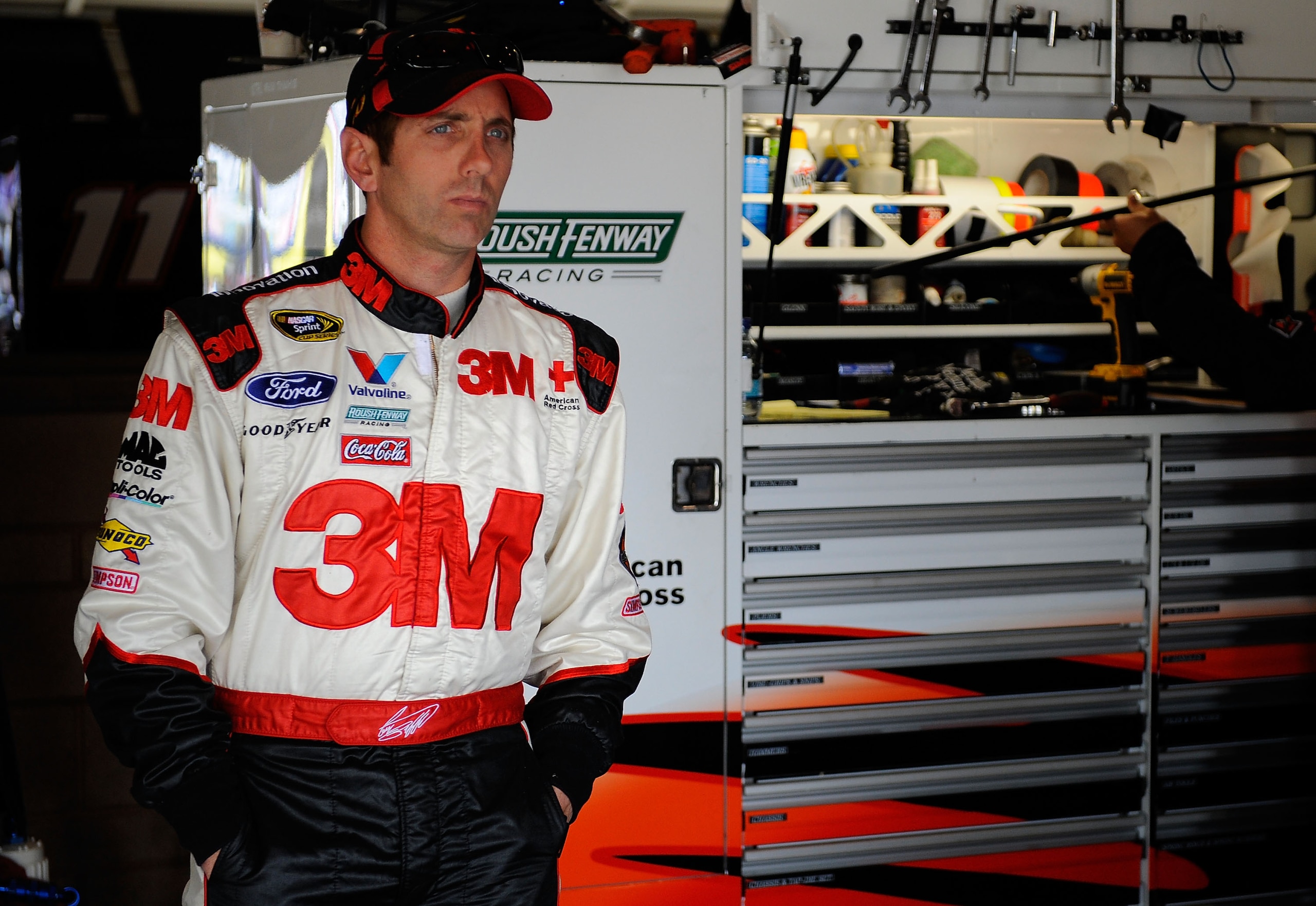 FONTANA, CA - MARCH 26:  Greg Biffle, driver of the #16 3M Ford, stands in the garage during practice for the NASCAR Sprint Cup Series Auto Club 400 at Auto Club Speedway on March 26, 2011 in Fontana, California.  (Photo by Jared C. Tilton/Getty Images fo