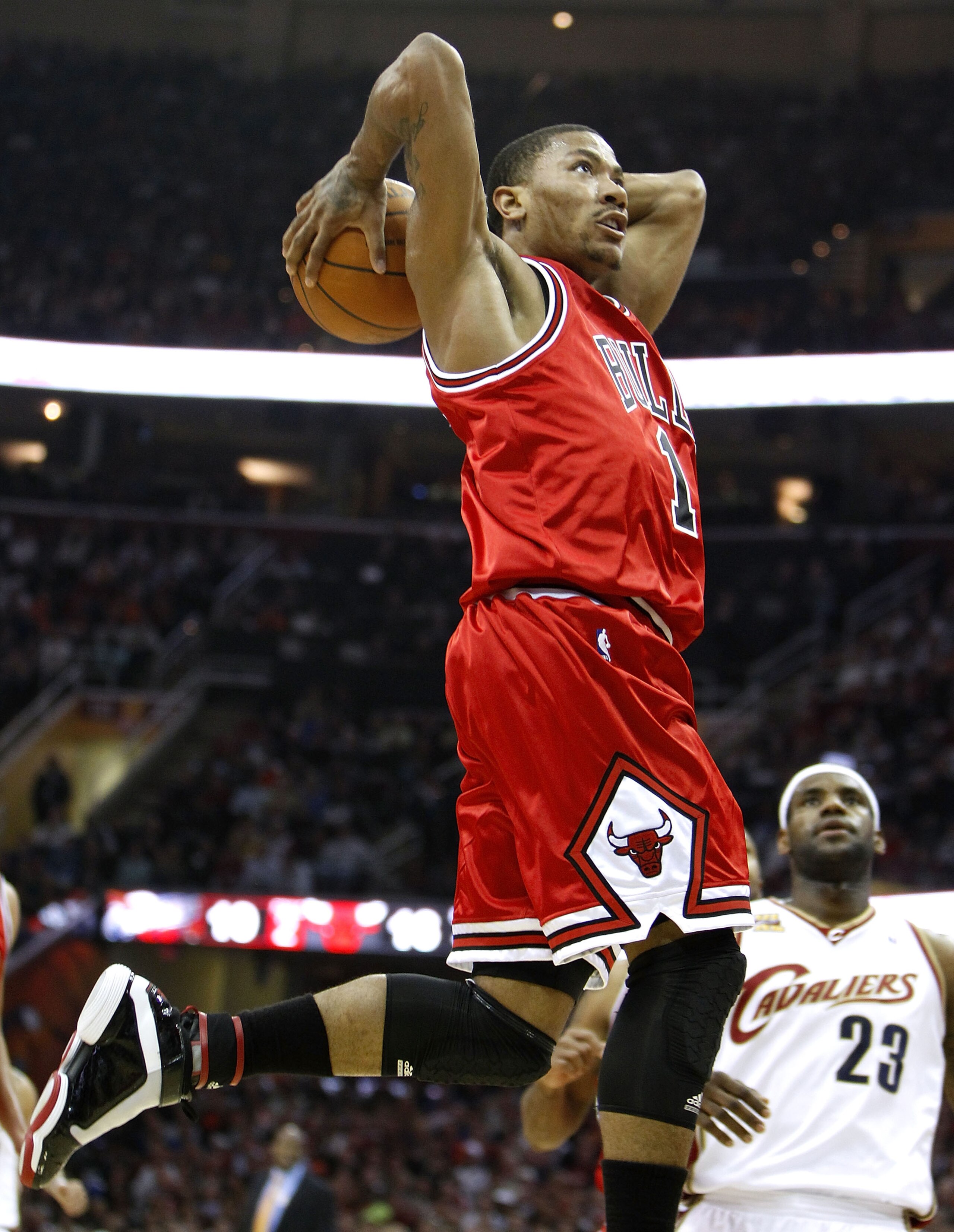 CLEVELAND - APRIL 19: Derrick Rose #1 Chicago Bulls gets in for a dunk in front of LeBron James #23 of the Cleveland Cavaliers in Game Two of the Eastern Conference Quarterfinals during the 2010 NBA Playoffs at Quicken Loans Arena on April 19, 2010 in Cle