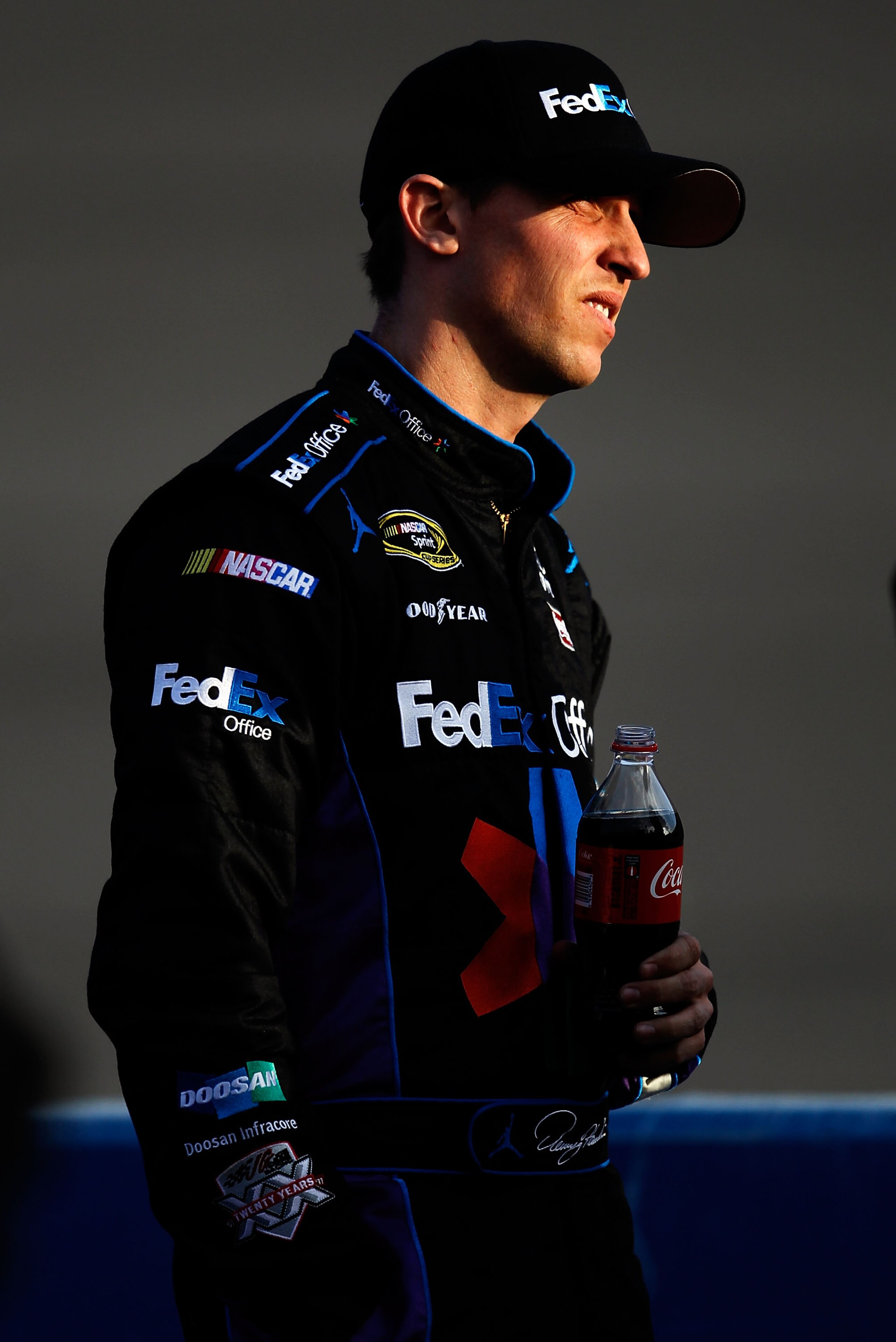 FONTANA, CA - MARCH 25:  Denny Hamlin, driver of the #11 FedEx Toyota, stands on pit road during qualifying for the NASCAR Sprint Cup Series Auto Club 400 at Auto Club Speedway on March 25, 2011 in Fontana, California.  (Photo by Tom Pennington/Getty Imag