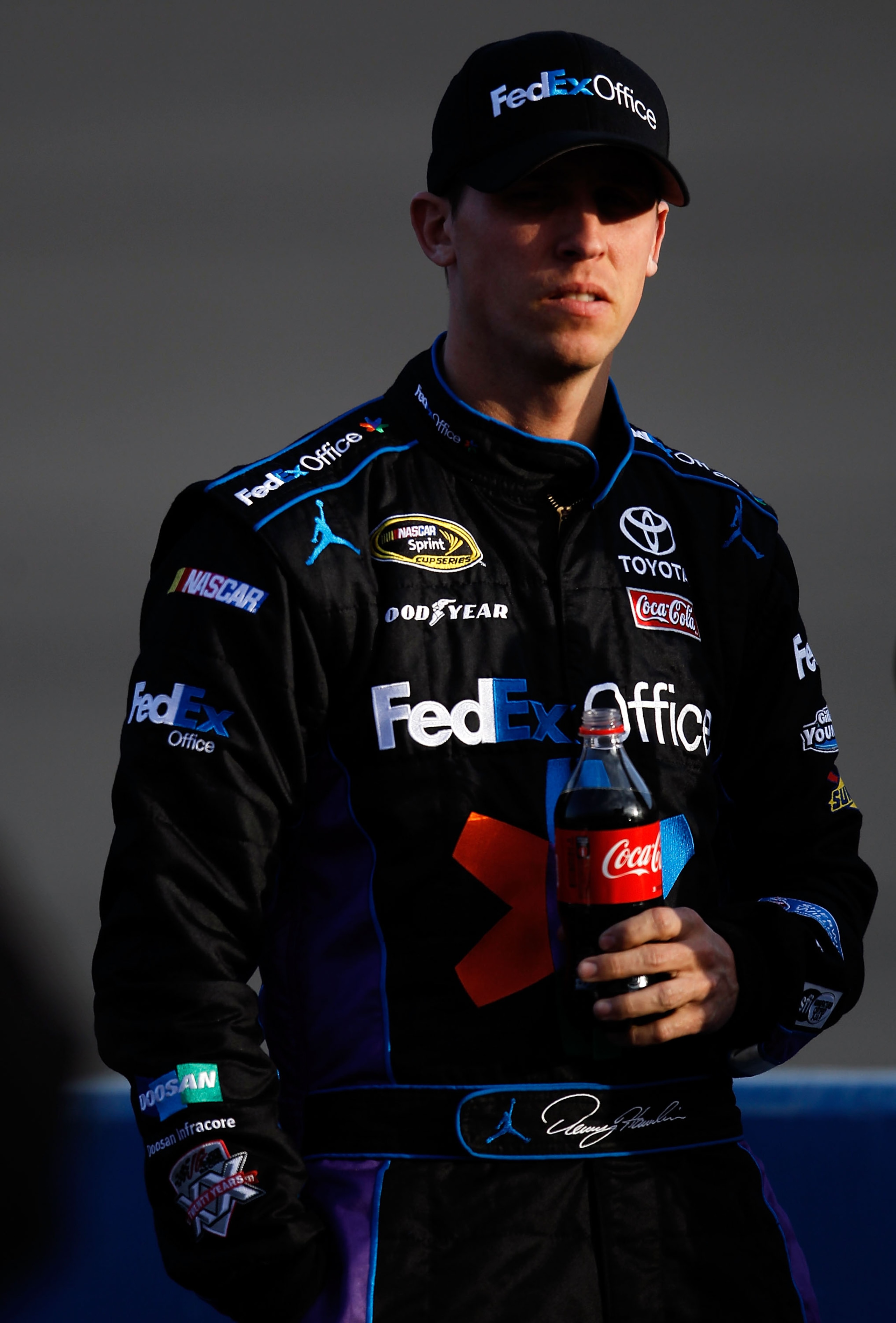 FONTANA, CA - MARCH 25:  Denny Hamlin, driver of the #11 FedEx Toyota, stands on pit road during qualifying for the NASCAR Sprint Cup Series Auto Club 400 at Auto Club Speedway on March 25, 2011 in Fontana, California.  (Photo by Tom Pennington/Getty Imag