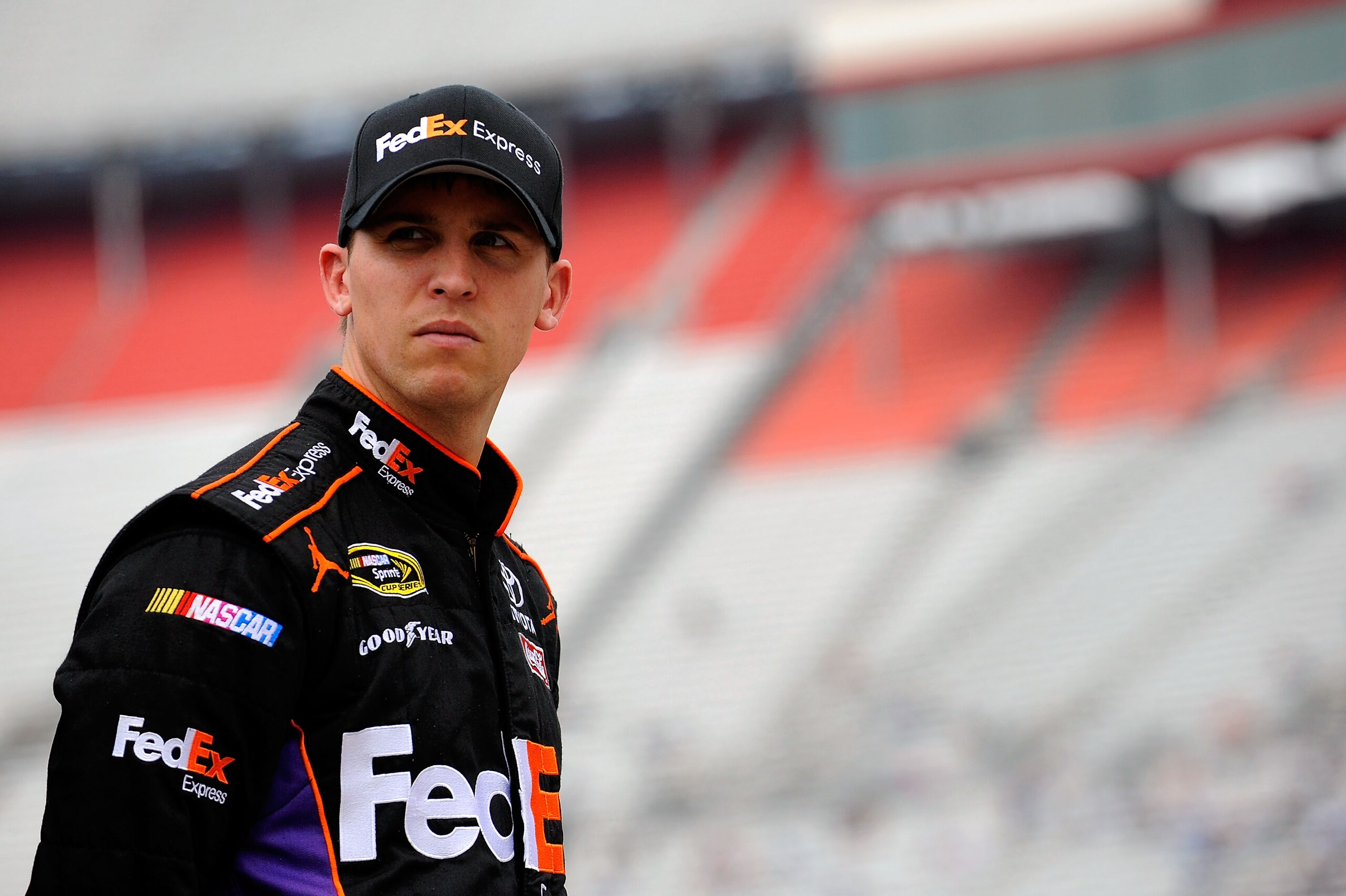 BRISTOL, TN - MARCH 18:  Denny Hamlin, driver of the #11 FedEx Express Toyota, stands in the garage area during practice for the NASCAR Sprint Cup Series Jeff Byrd 500 Presented By Food City at Bristol Motor Speedway on March 18, 2011 in Bristol, Tennesse