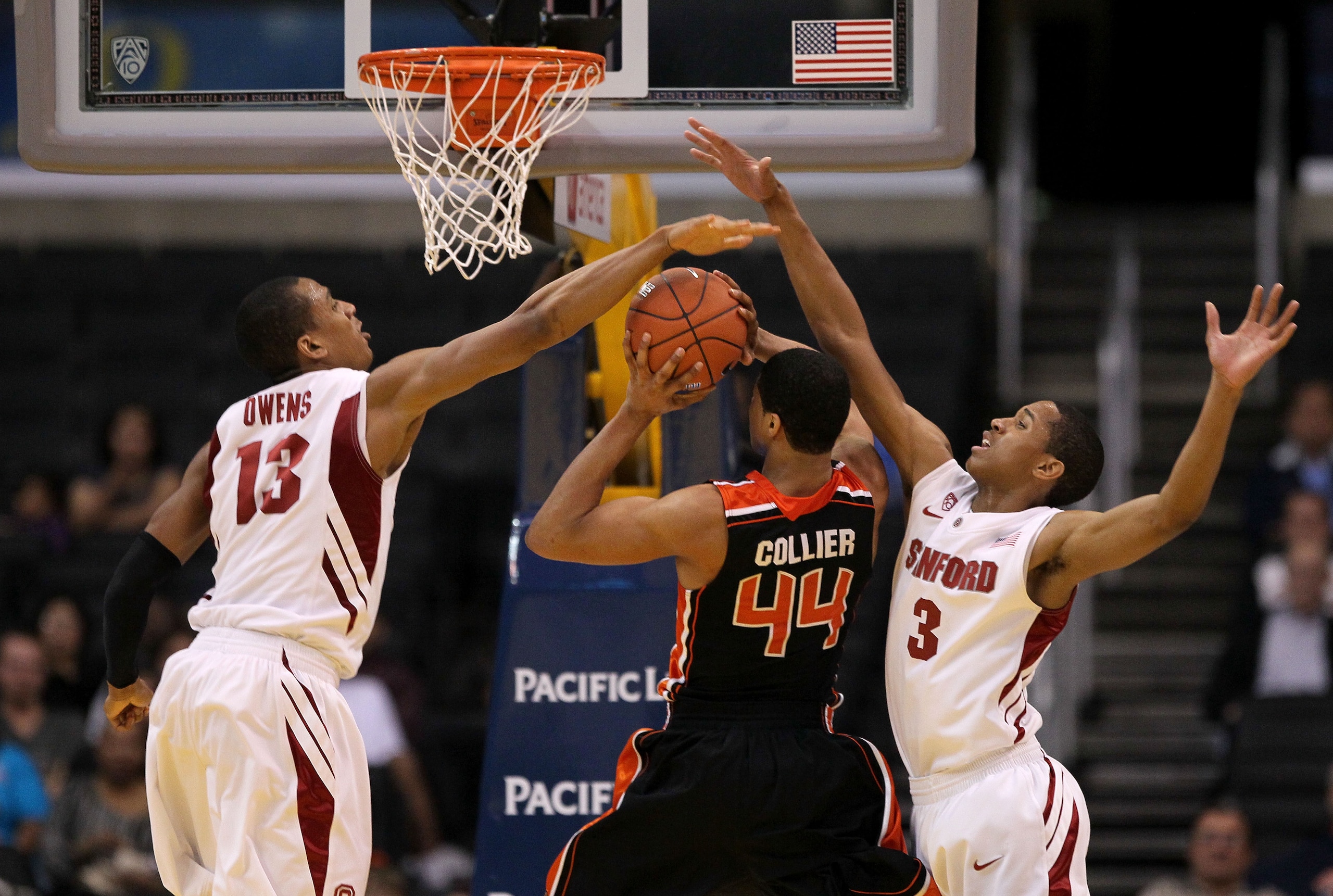 LOS ANGELES, CA - MARCH 09:  Devon Collier #44 of the Oregon State Beavers goes up for a shot between Anthony Brown #3 and Josh Owens #13 of the Stanford Cardinal in the second half of the first round of the 2011 Pacific Life Pac-10 Men's Basketball Tourn