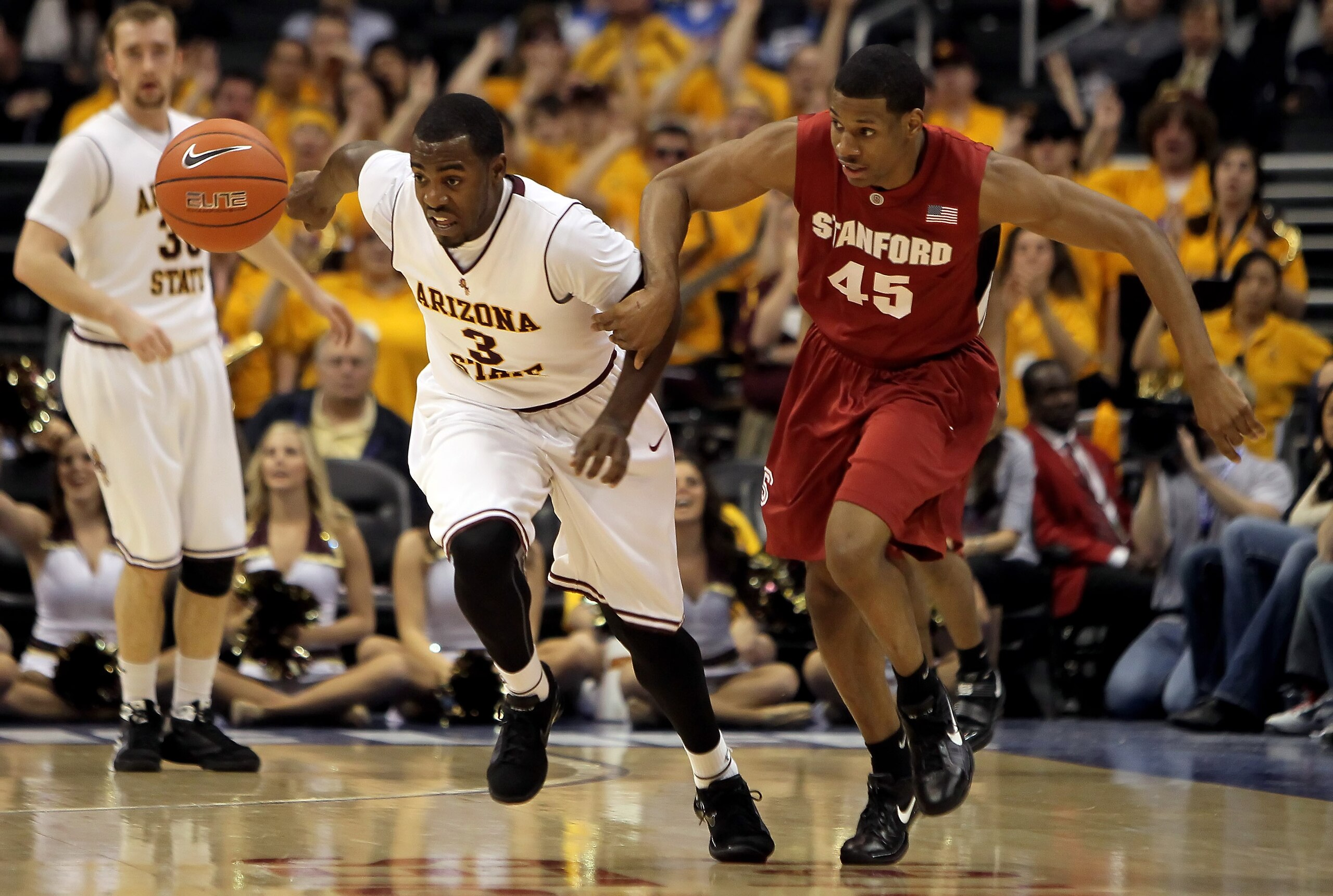 LOS ANGELES, CA - MARCH 11:  Ty Abbott #3 of the Arizona State Sun Devils and Jeremy Green #45 of the Stanford Cardinal fight for a loose ball in the first half during the Quarterfinals of the Pac-10 Basketball Tournament at Staples Center on March 11, 20