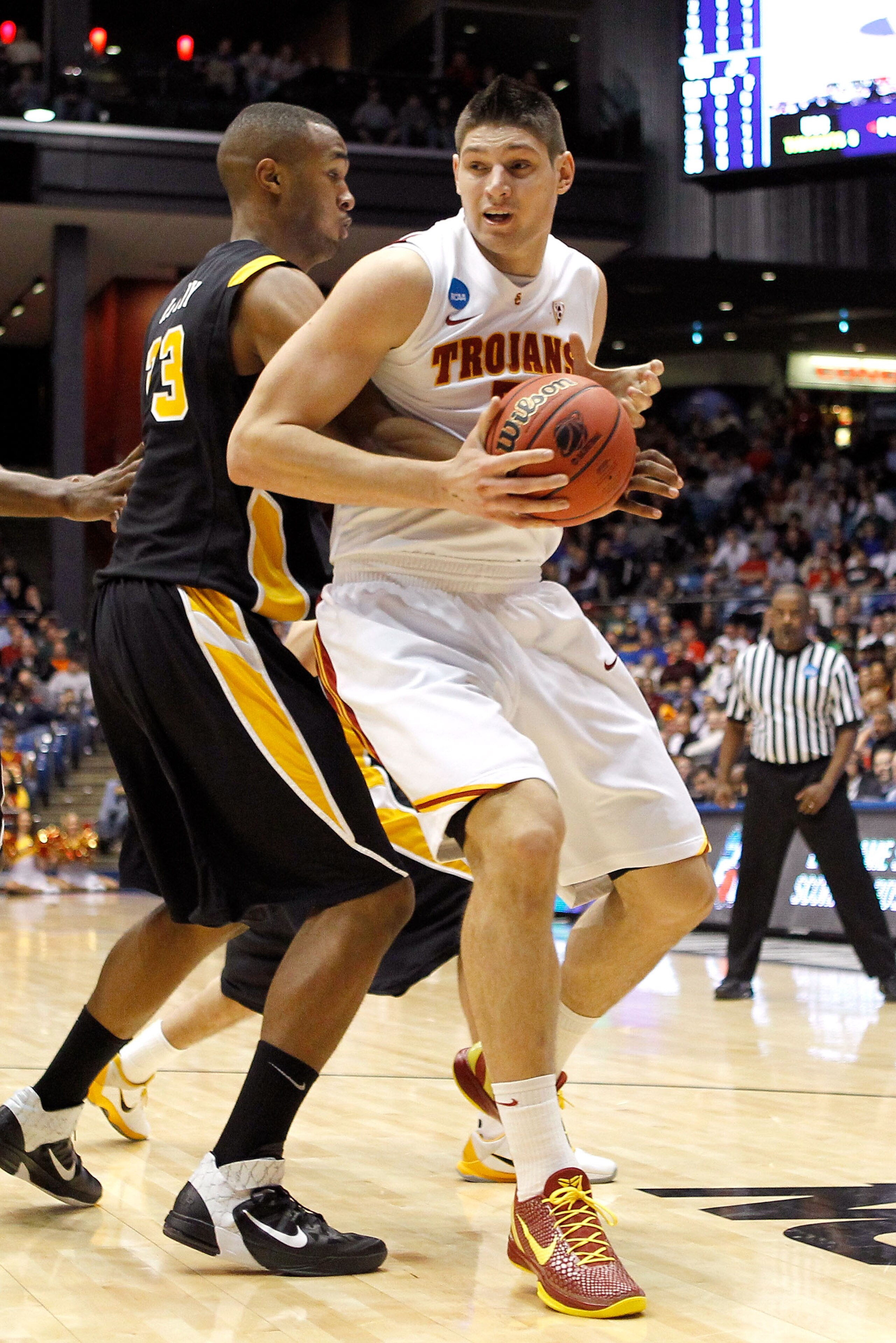 DAYTON, OH - MARCH 16: Nikola Vucevic #5 of the USC Trojans handles the ball against D.J. Haley #33 of the Virginia Commonwealth Rams during the first round of the 2011 NCAA men's basketball tournament at UD Arena on March 16, 2011 in Dayton, Ohio.  (Phot