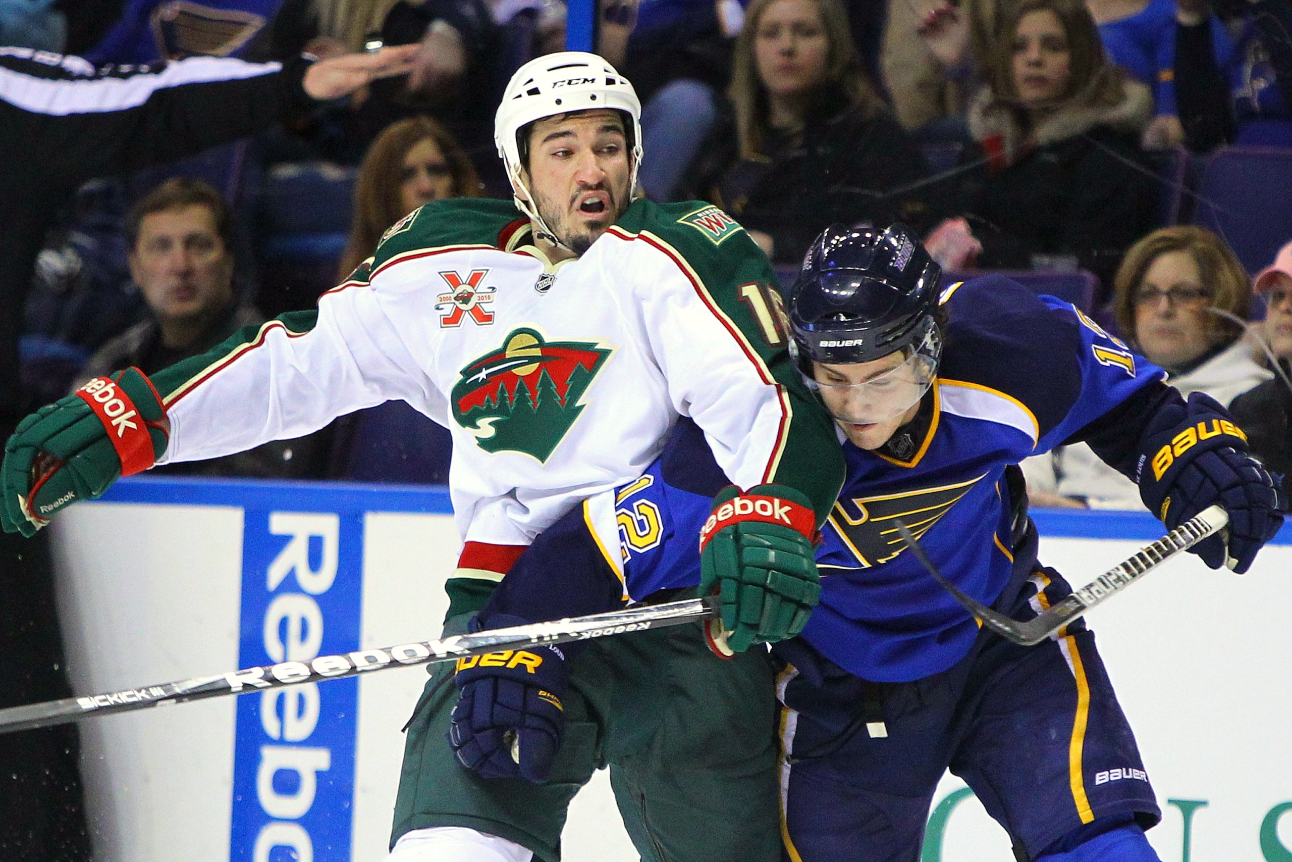 ST. LOUIS, MO - MARCH 29: Kevin Shattenkirk #12 of the St. Louis Blues defends against Brad Staubitz #16 of the Minnesota Wild at the Scottrade Center on March 29, 2011 in St. Louis, Missouri.  (Photo by Dilip Vishwanat/Getty Images)