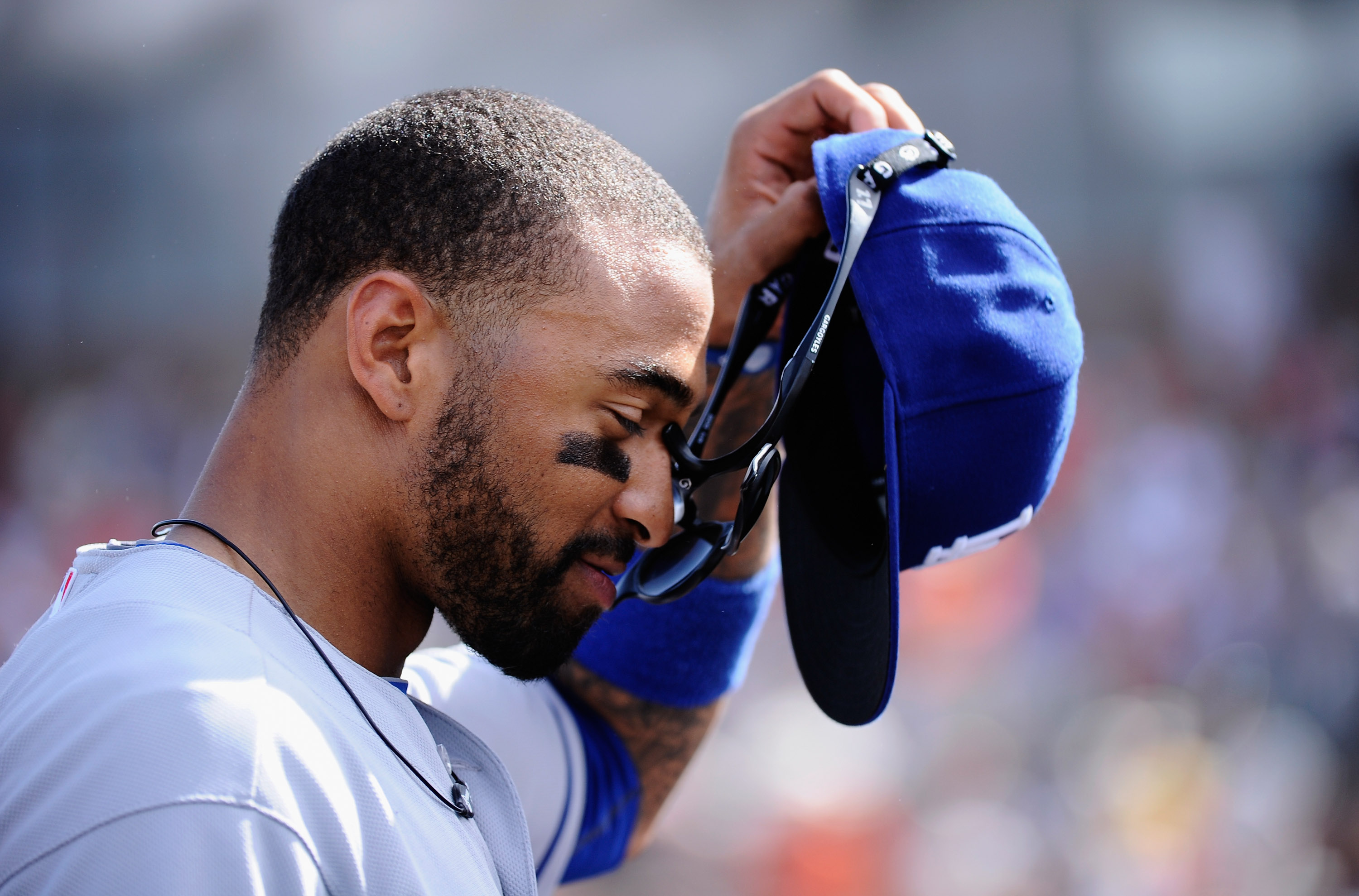 SCOTTSDALE, AZ - MARCH 18:  Matt Kemp #27 of the Los Angeles Dodgers takes off his baseball cap and glasses after misplaying a fly ball hit by Mike Fontenot #14 of the San Francisco Giants that scored two runs during the fifth inning of the baseball game