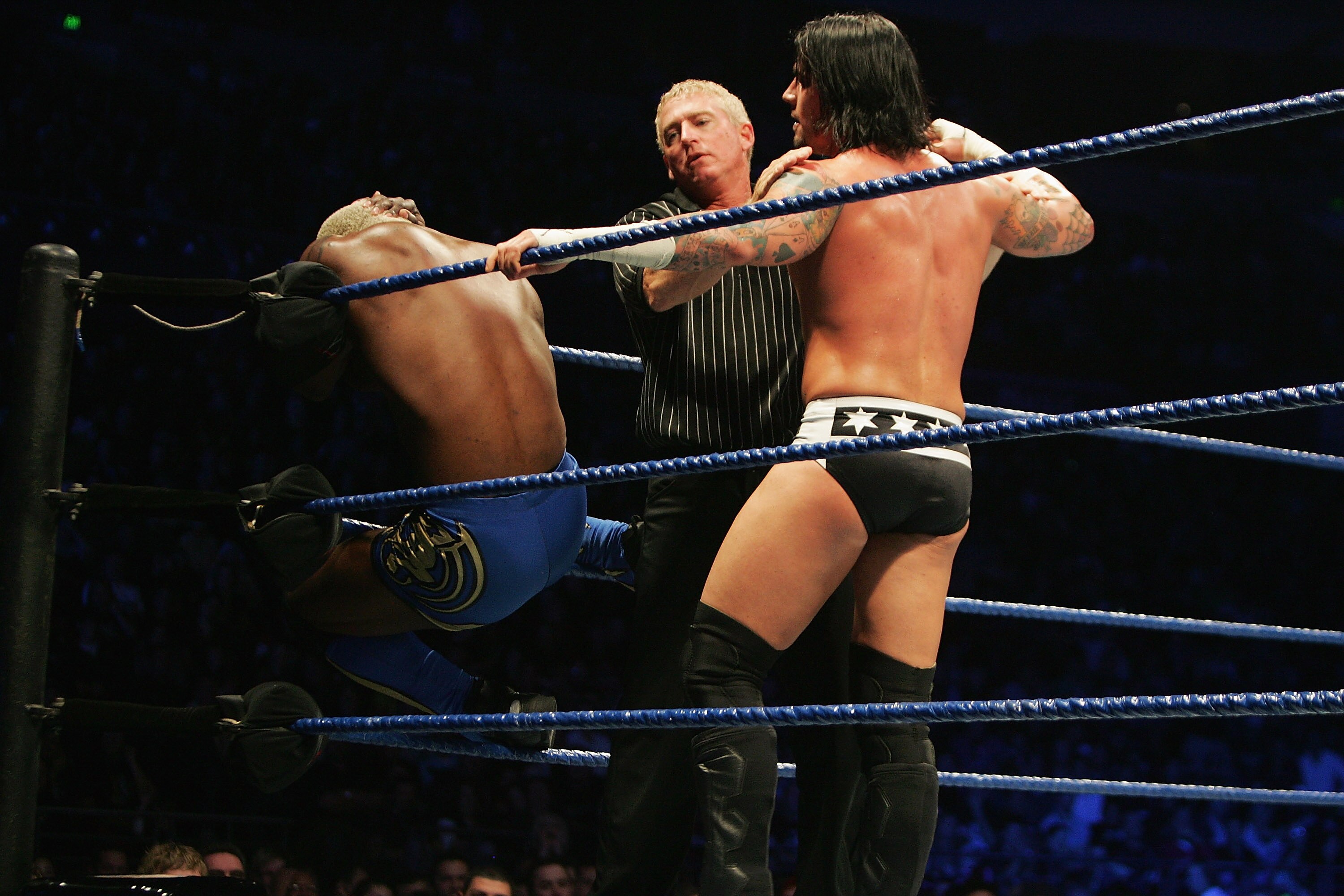 SYDNEY, AUSTRALIA - JUNE 15:  The referee seperates CM Punk (L) from Shelton Benjamin (R) during WWE Smackdown at Acer Arena on June 15, 2008 in Sydney, Australia.  (Photo by Gaye Gerard/Getty Images)