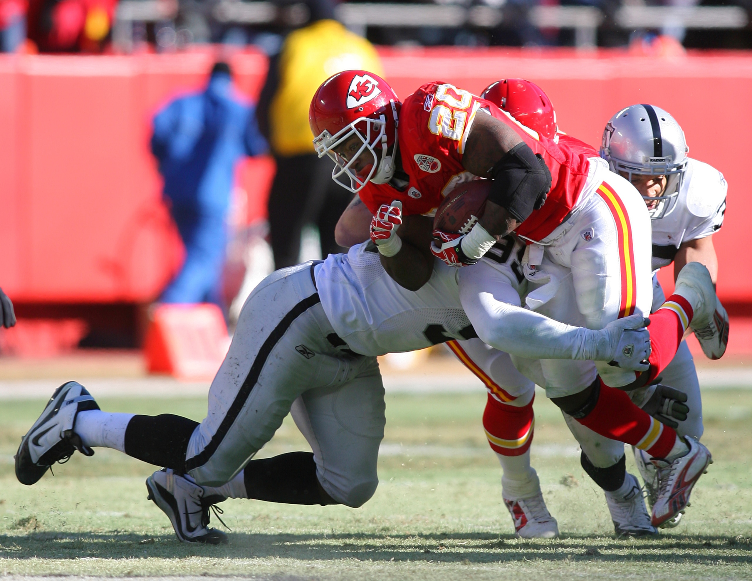 KANSAS CITY, MO - JANUARY 02: Running back Thomas Jones #25 of the Kansas City Chiefs is tackled by defensive end Lamarr Houston #99 of the Oakland Raiders in a game at Arrowhead Stadium on January 2, 2011 in Kansas City, Missouri. (Photo by Tim Umphrey KANSAS CITY, MO - JANUARY 02: Running back Thomas Jones #25 of the Kansas City Chiefs is tackled by defensive end Lamarr Houston #99 of the Oakland Raiders in a game at Arrowhead Stadium on January 2, 2011 in Kansas City, Missouri. (Photo by Tim Umphrey