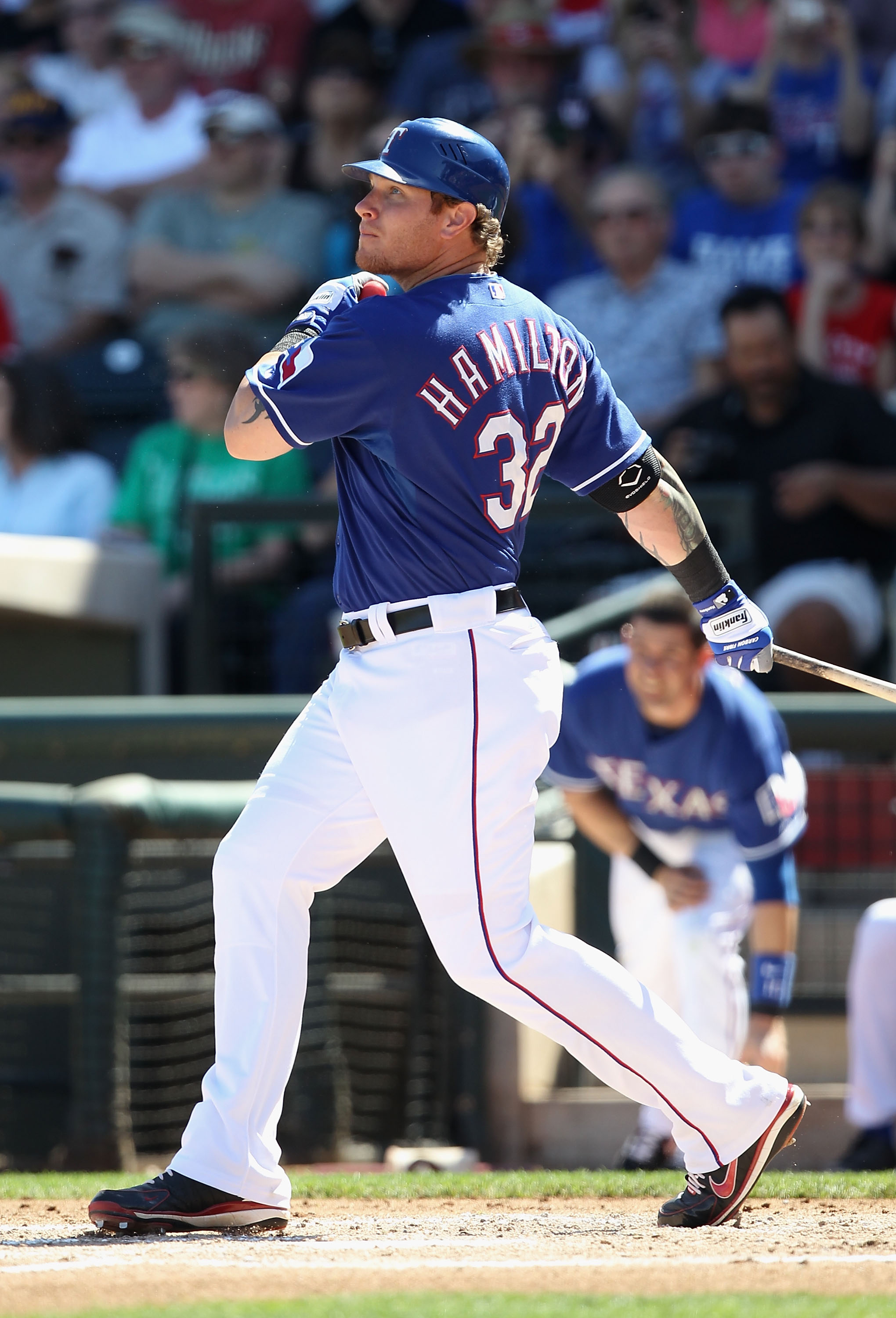 SURPRISE, AZ - MARCH 11:  Josh Hamilton #32 of the Texas Rangers hits a RBI single against the Cincinnati Reds during the first inning of the spring training game at Surprise Stadium on March 11, 2011 in Surprise, Arizona.  (Photo by Christian Petersen/Ge