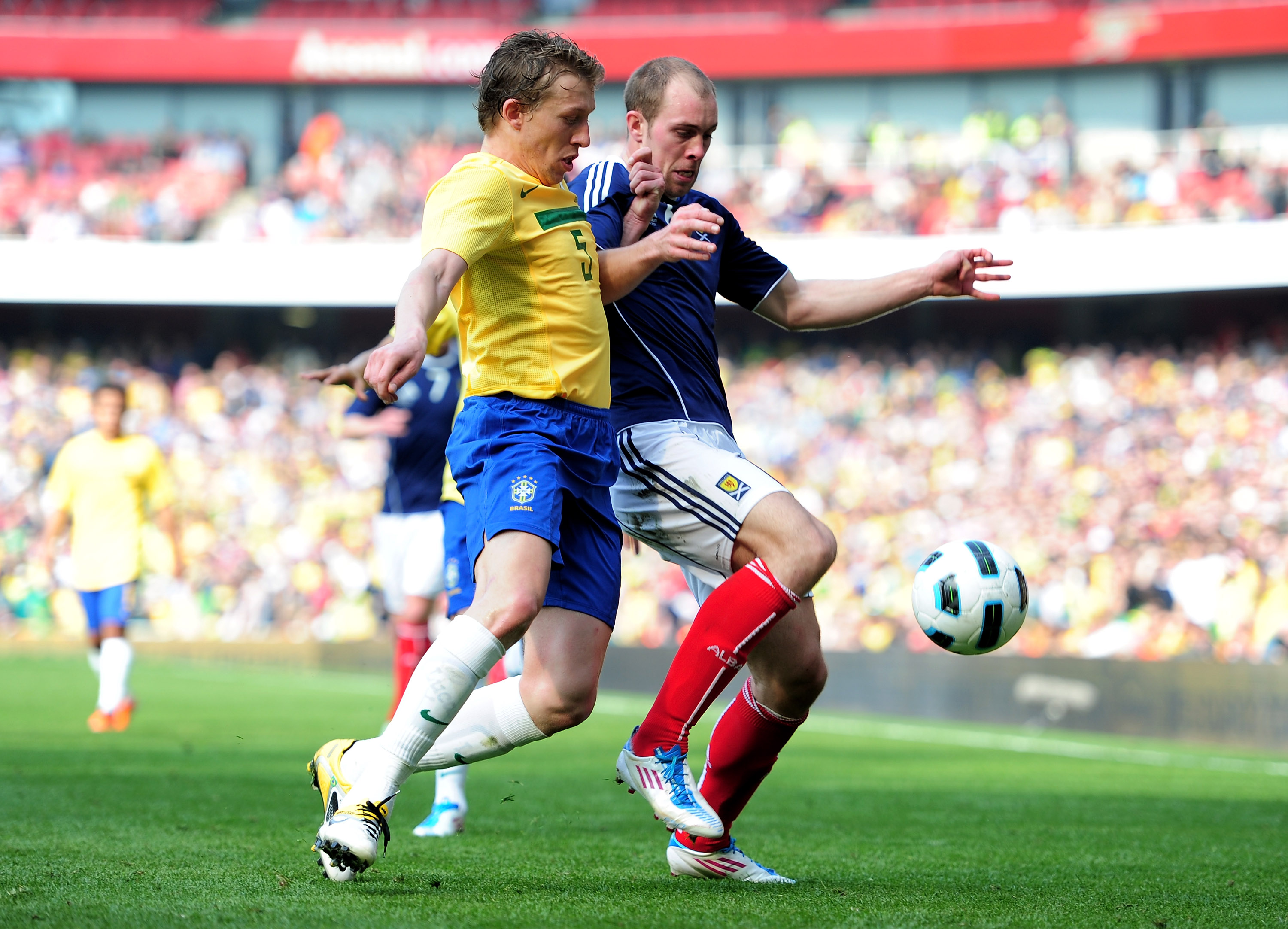 LONDON, ENGLAND - MARCH 27:  Lucas Leiva of Brazil battles for the ball with Steven Whittaker of Scotland during the International friendly match between Brazil and Scotland at Emirates Stadium on March 27, 2011 in London, England.  (Photo by Jamie McDona