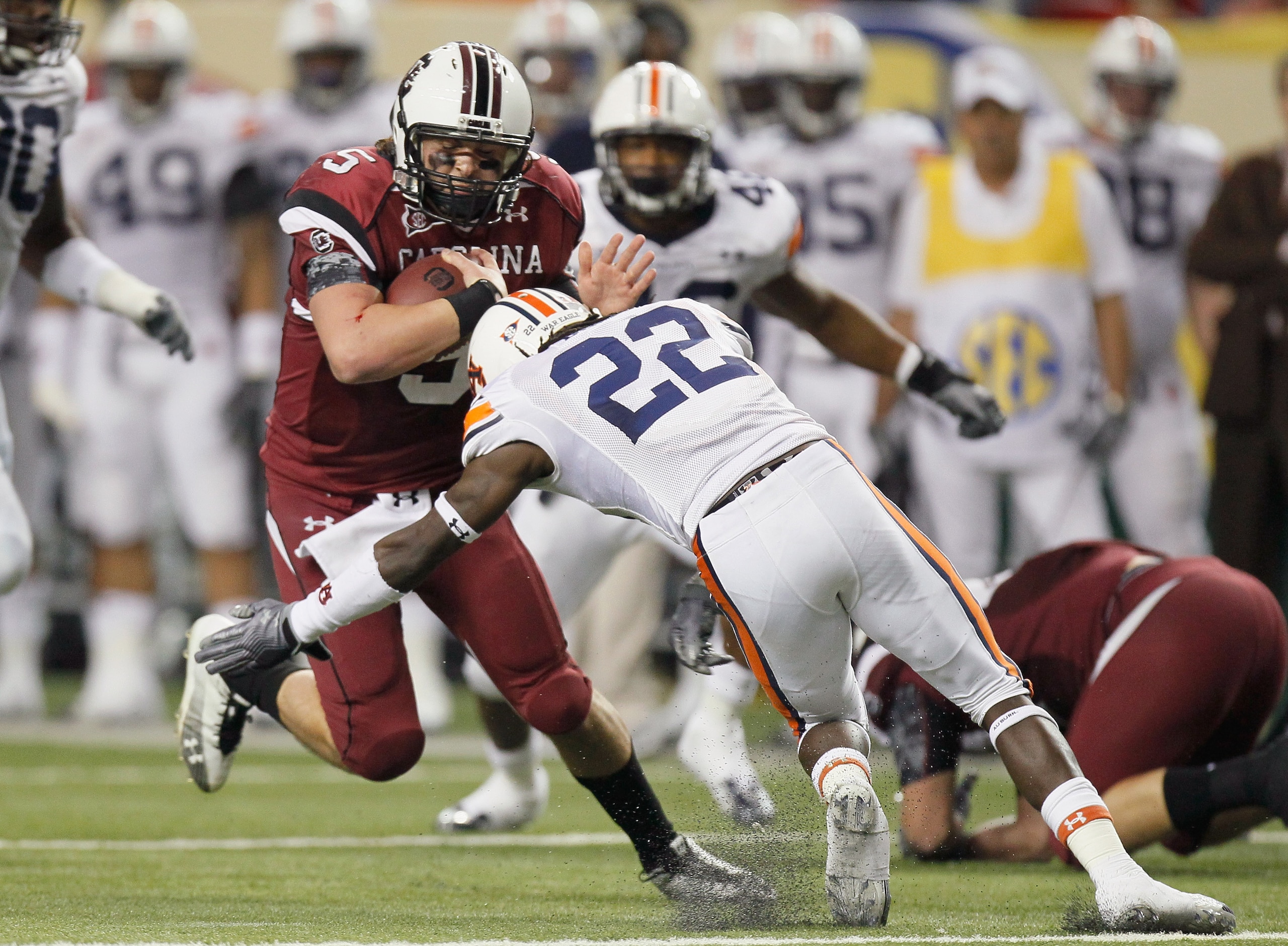 ATLANTA, GA - DECEMBER 04: Stephen Garcia #5 of the South Carolina Gamecocks is tackled by T'Sharvan Bell #22 of the Auburn Tigers during the 2010 SEC Championship at Georgia Dome on December 4, 2010 in Atlanta, Georgia. (Photo by Kevin C. Cox/Getty Ima ATLANTA, GA - DECEMBER 04: Stephen Garcia #5 of the South Carolina Gamecocks is tackled by T'Sharvan Bell #22 of the Auburn Tigers during the 2010 SEC Championship at Georgia Dome on December 4, 2010 in Atlanta, Georgia. (Photo by Kevin C. Cox/Getty Ima