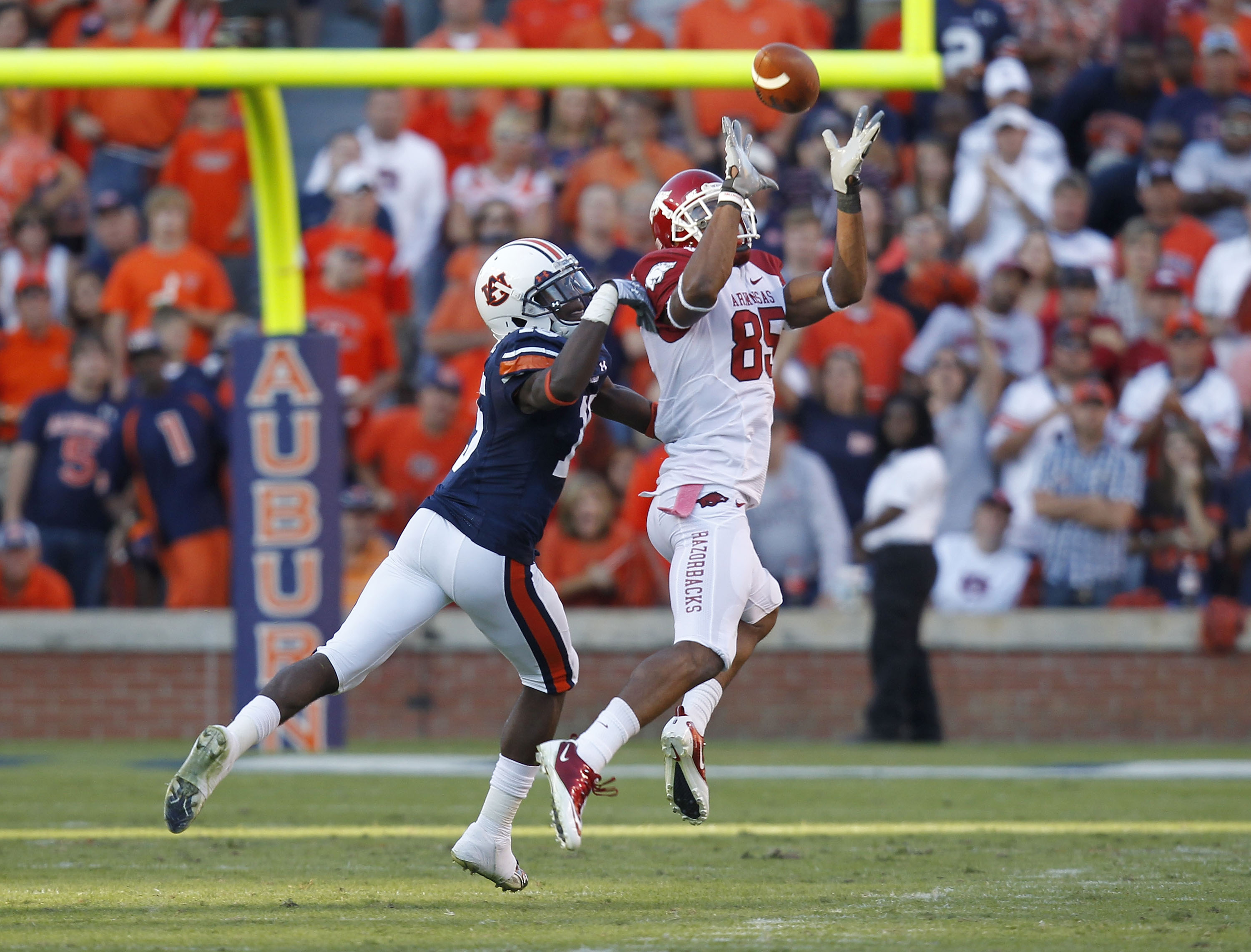 AUBURN - OCTOBER 16:  Wide receiver Greg Childs #85 of the Arkansas Razorbacks catches a pass behind defensive back Neiko Thorpe #15 of the Auburn Tigers during the game at Jordan-Hare Stadium on October 16, 2010 in Auburn, Alabama.  The Tigers beat the R
