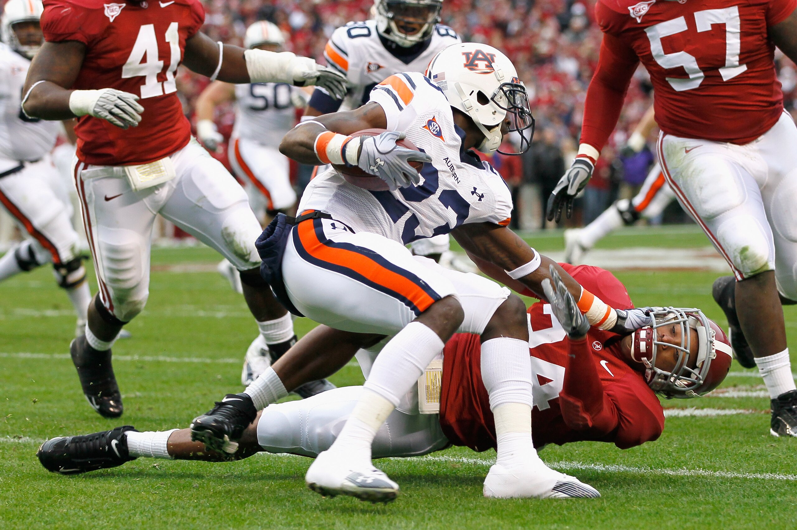 TUSCALOOSA, AL - NOVEMBER 26: Onterio McCalebb #23 of the Auburn Tigers is wrestled to the ground by DeQuan Menzie #24 of the Alabama Crimson Tide at Bryant-Denny Stadium on November 26, 2010 in Tuscaloosa, Alabama. (Photo by Kevin C. Cox/Getty Images) TUSCALOOSA, AL - NOVEMBER 26: Onterio McCalebb #23 of the Auburn Tigers is wrestled to the ground by DeQuan Menzie #24 of the Alabama Crimson Tide at Bryant-Denny Stadium on November 26, 2010 in Tuscaloosa, Alabama. (Photo by Kevin C. Cox/Getty Images)
