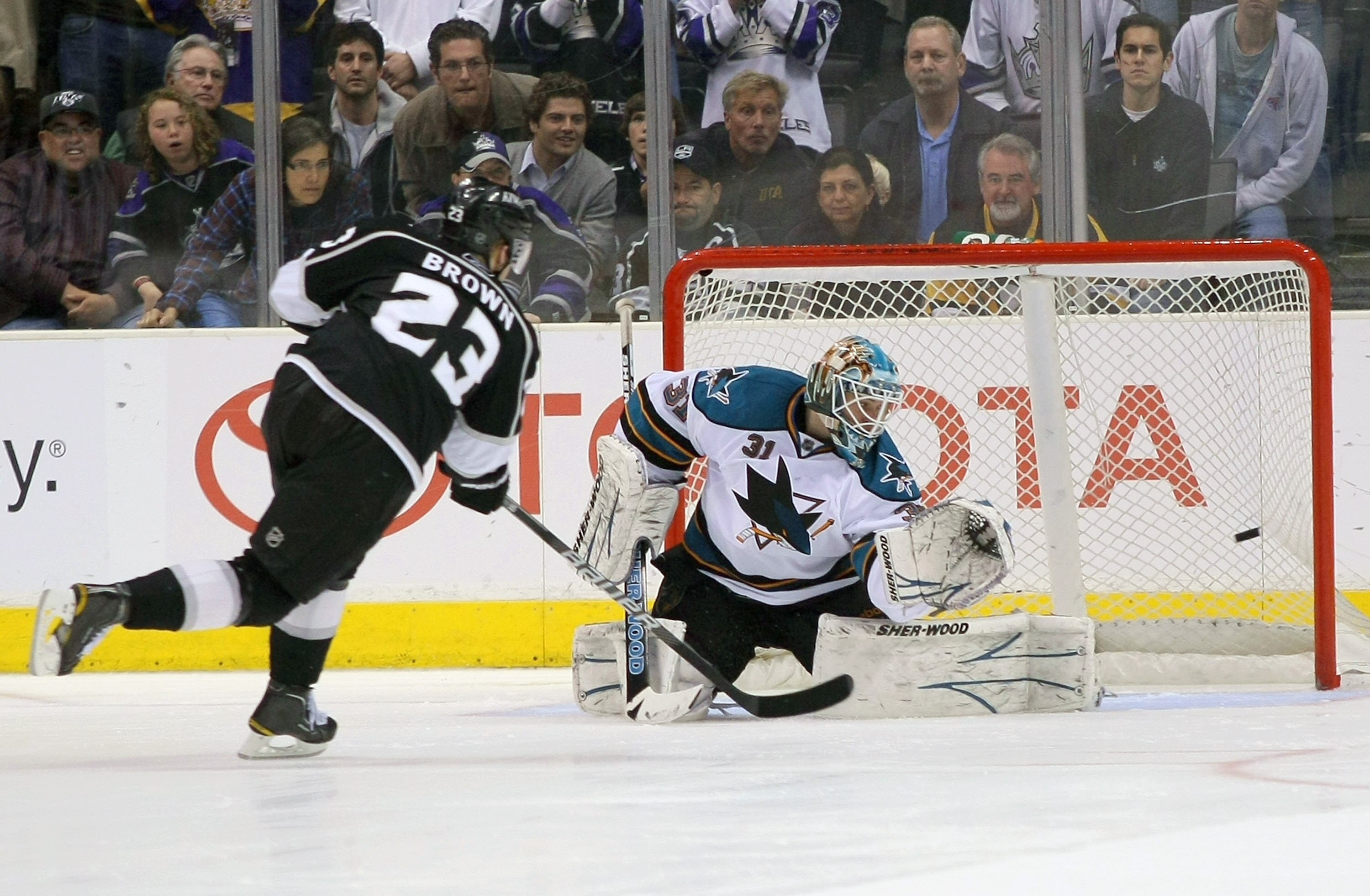 LOS ANGELES, CA - MARCH 24:  Dustin Brown #23 of the Los Angeles Kings scores against goaltender Antti Niemi #31 of the San Jose Sharks to win the game 4-3 in shootout overtime in their NHL game at Staples Center on March 24, 2011 in Los Angeles, Californ