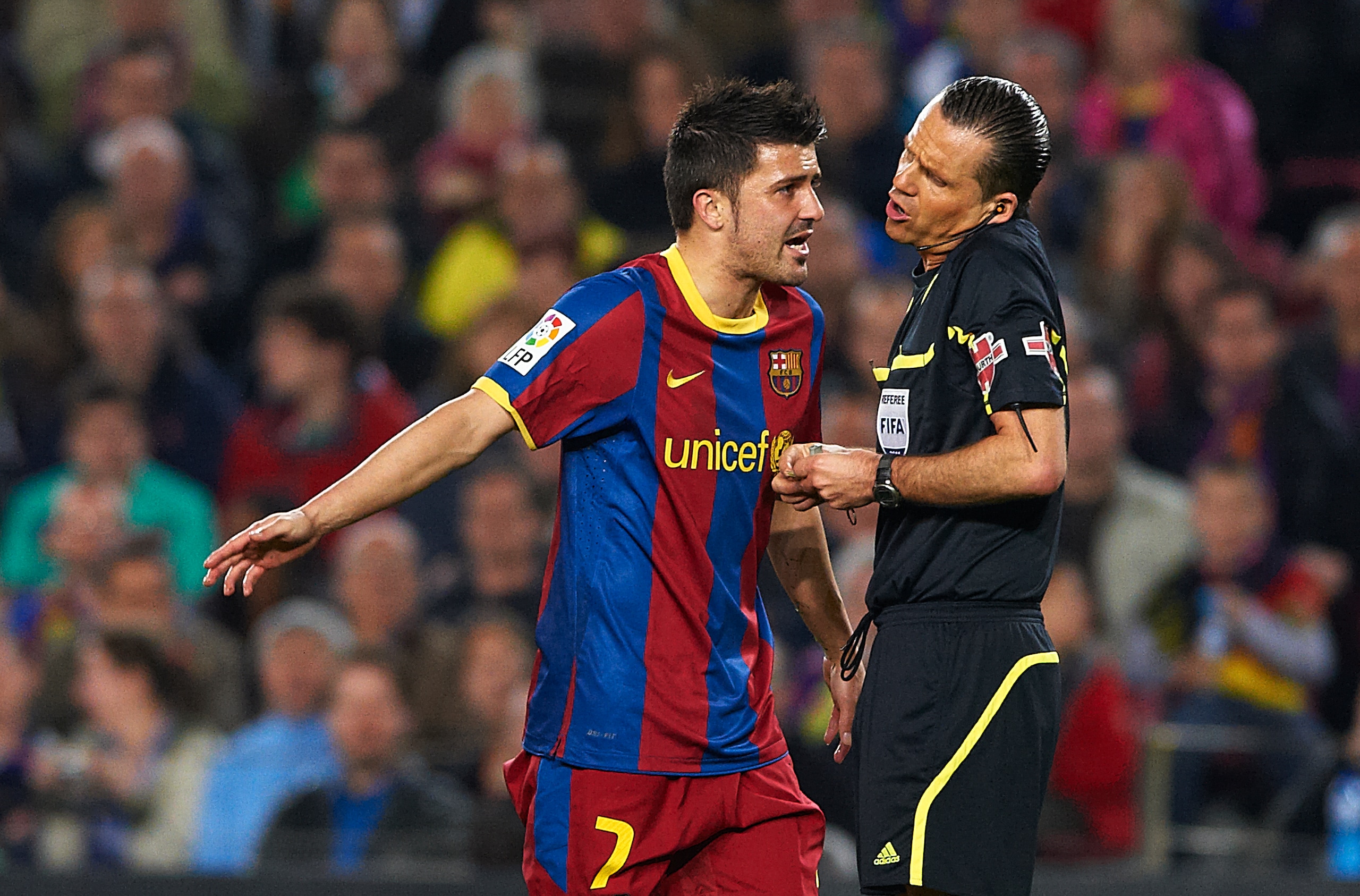 BARCELONA, SPAIN - MARCH 19:  David Villa of Barcelona speaks with referee Cesar Mu?iz Fernandez during the La Liga match between Barcelona and Getafe at Camp Nou on March 19, 2011 in Barcelona, Spain. Barcelona won 2-1.  (Photo by Manuel Queimadelos Alon