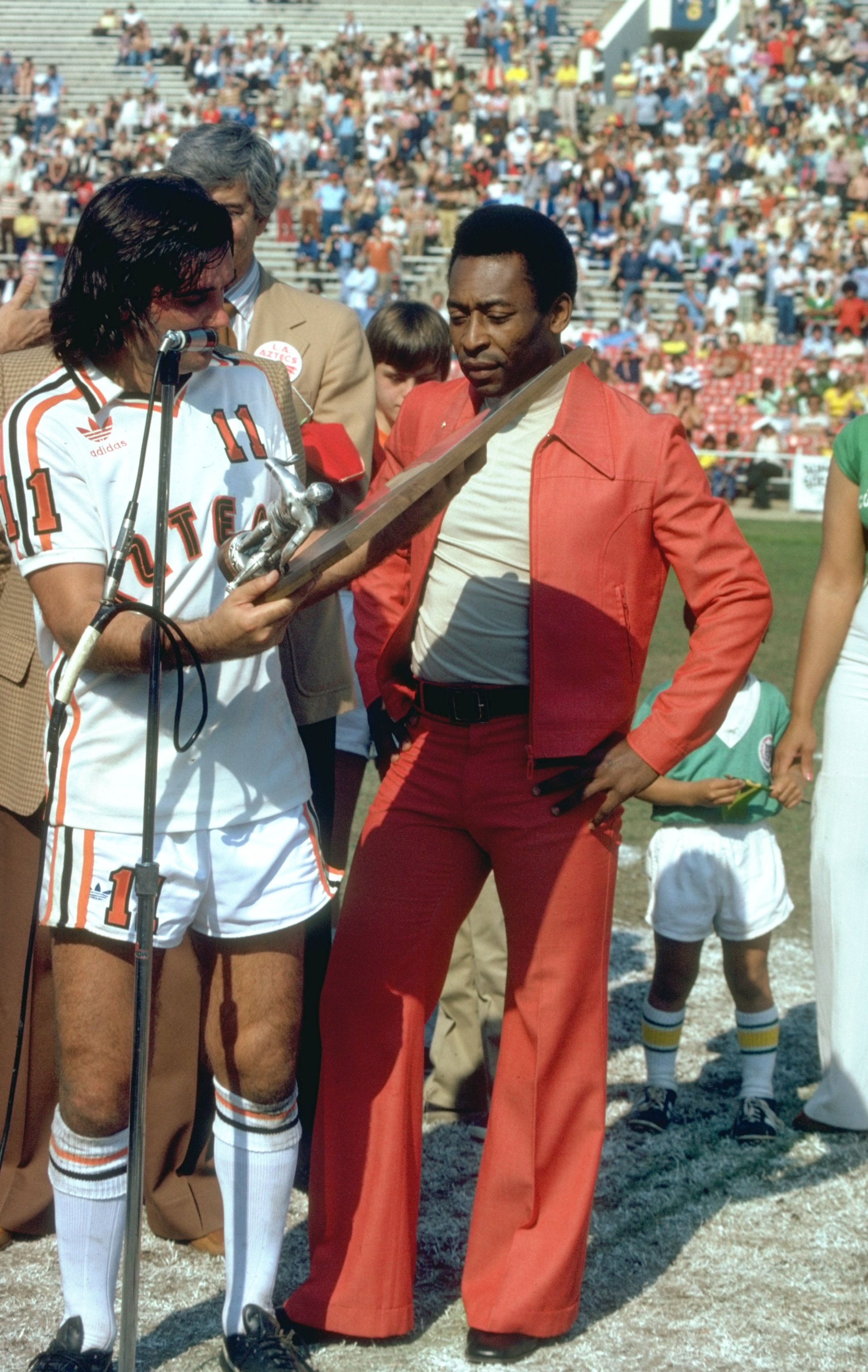 Apr 1987:  Pele (right) of Brazil is presented with the Greatest Soccer Player Trophy by George Best of Aztecs before an American League match between Aztecs and NY Cosmos at the Rose Bowl in Los Angeles, California, USA. \ Mandatory Credit: Tony  Duffy/A