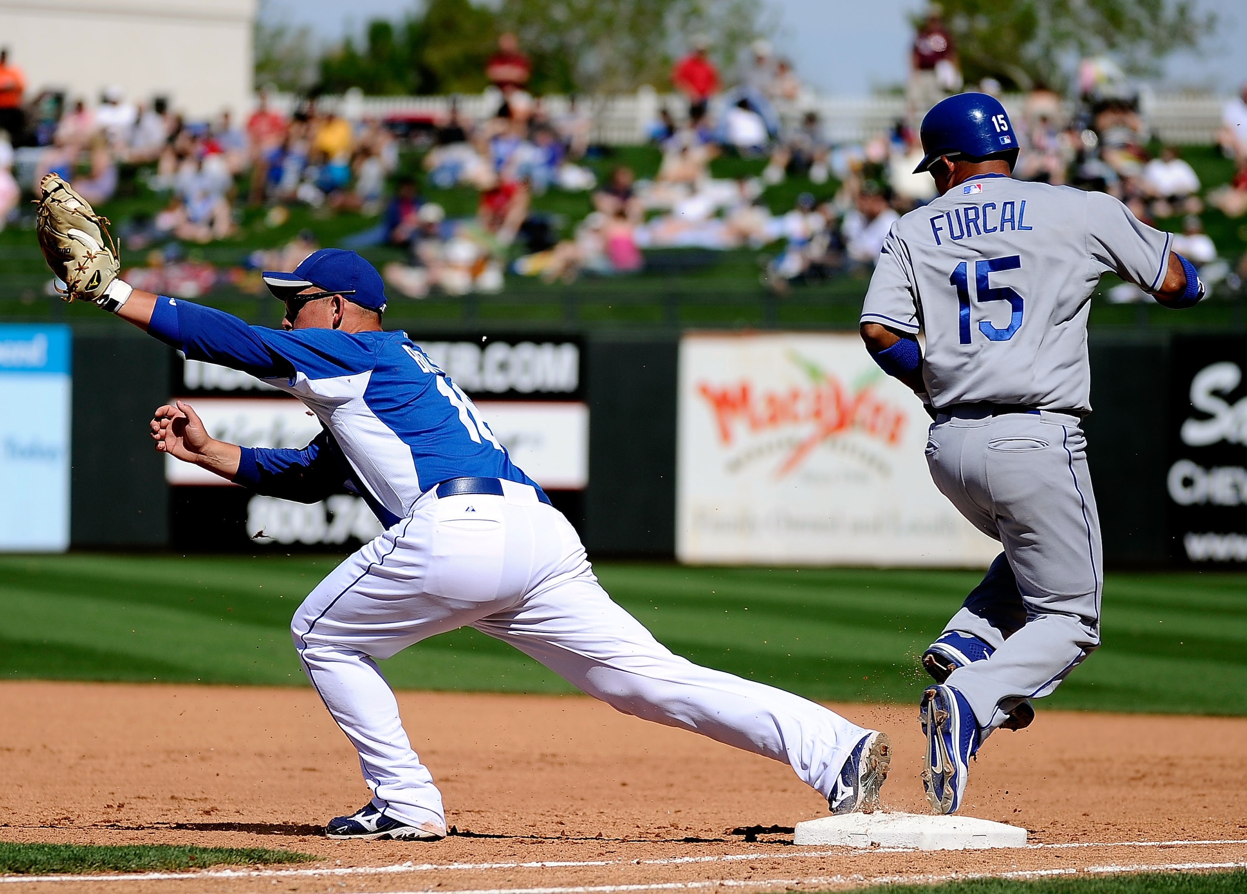 SURPRISE, AZ - MARCH 12:  Rafael Furcal #15 of the the Los Angeles Dodgers is beat by Billy Butler #16 of the Kansas City Royals in the spring training baseball game at Surprise Stadium on March 12, 2011 in Surprise, Arizona.  (Photo by Kevork Djansezian/