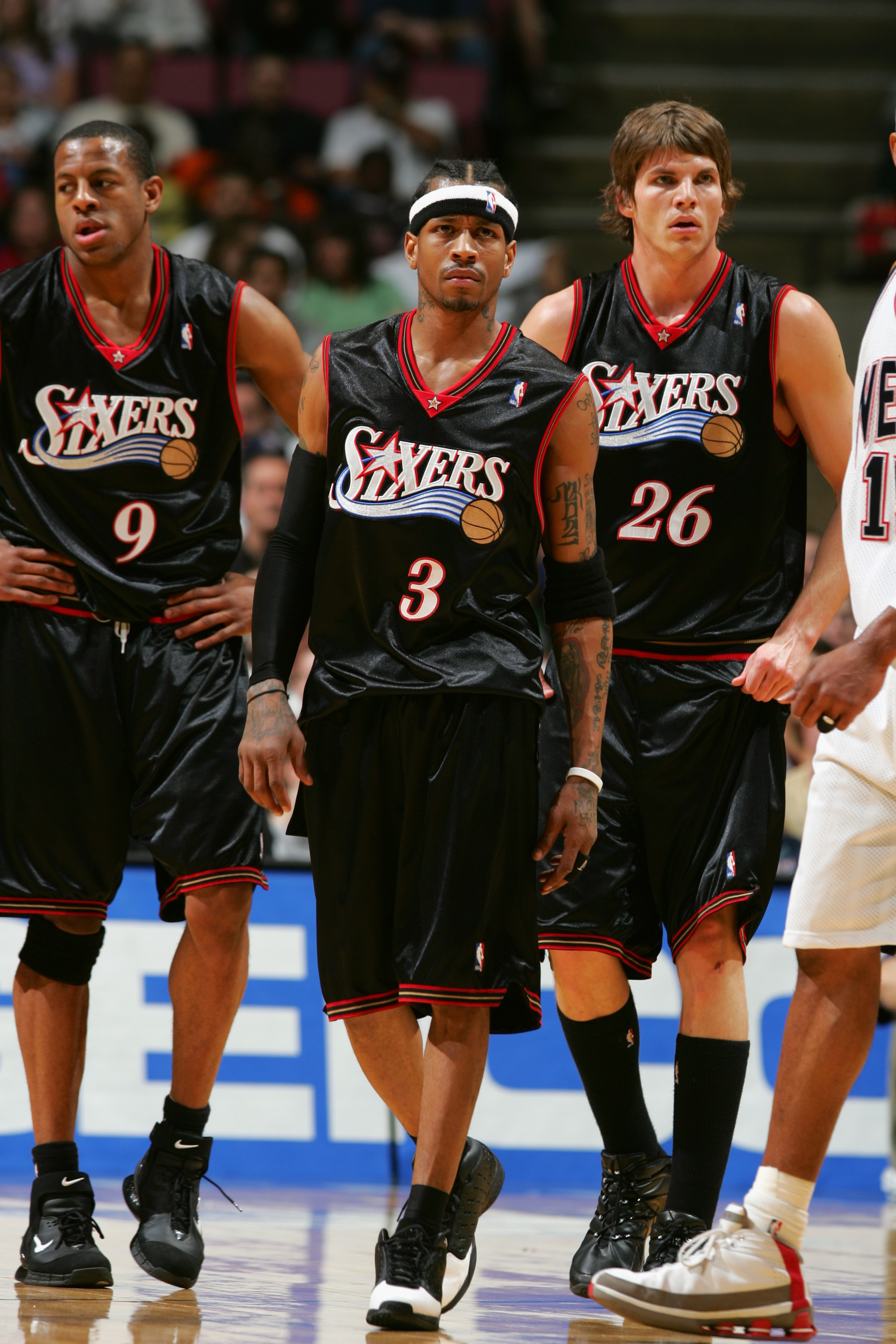 EAST RUTHERFORD, NJ - APRIL 17:  (Left to Right) Andre Iguodala #9 of the Philadelphia 76ers walks with his teammates Allen Iverson #3 and Kyle Korver #26 during the game against the New Jersey Nets on April 17, 2005 at Continental Airlines Arena in East